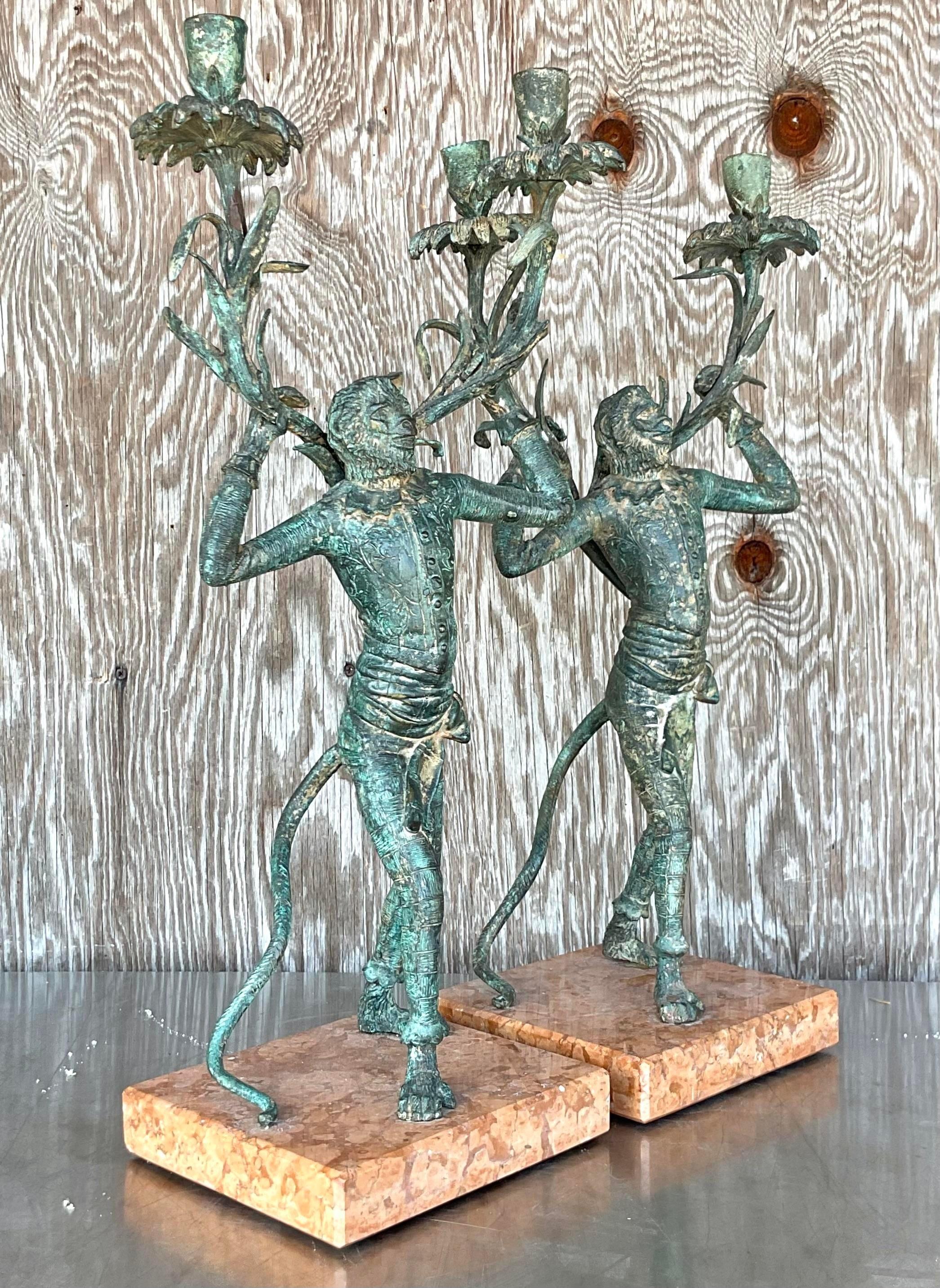 A spectacular pair of monumental vintage Regency candelabras. A handsome pair of bronze monkeys with incredible patina from time. Rest on gorgeous marble plinths. Acquired from a Palm Beach estate.