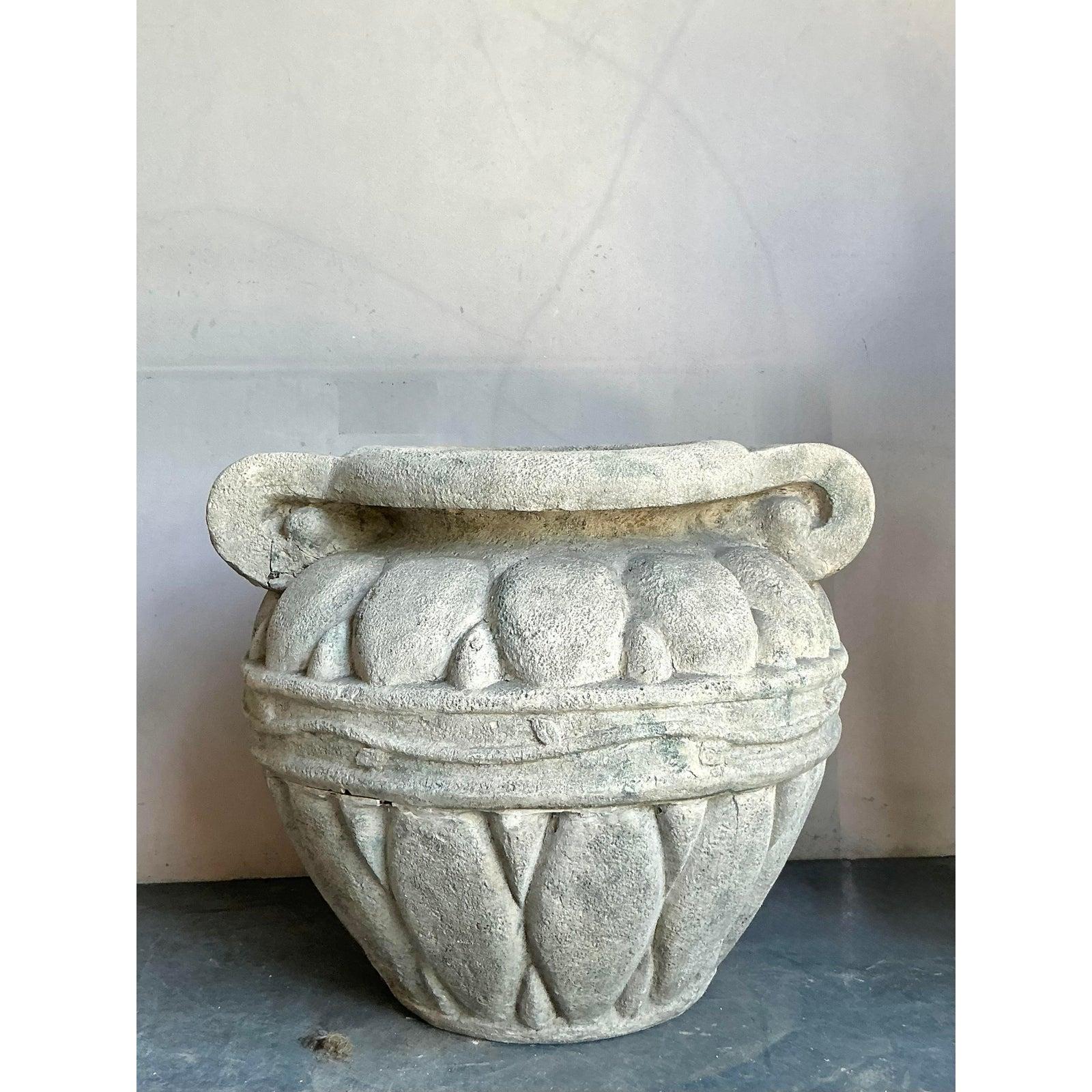 Make a truly grand statement with this monumental vintage planter. Designed in the elegant Regency style, this piece features a classic urn shape adorned with bold, sculptural details and scrolled handles, reminiscent of ancient European garden