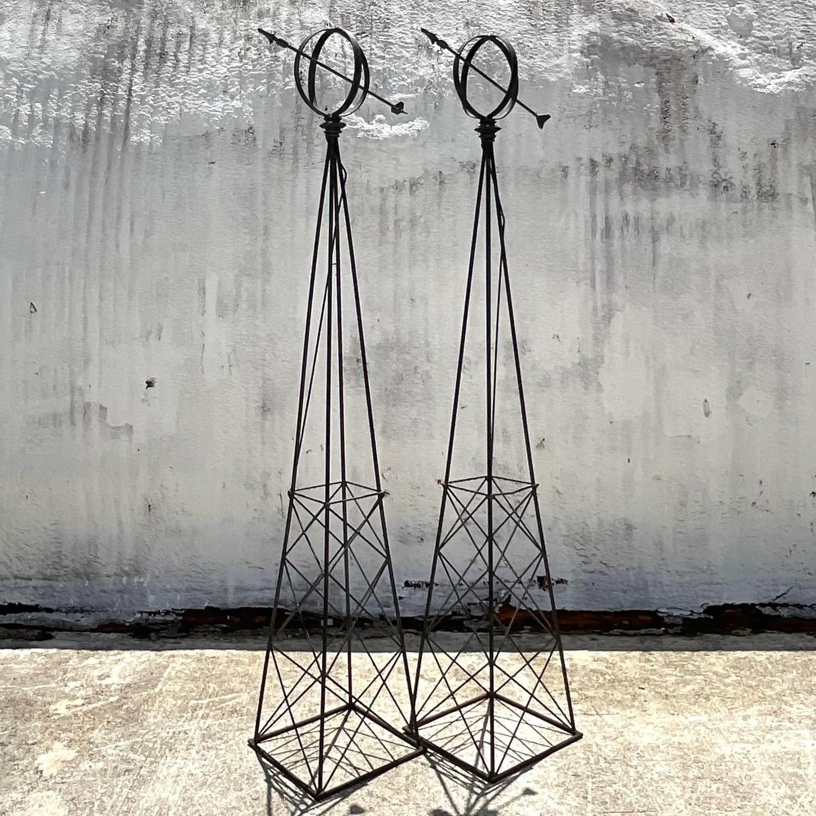 Fantastic pair of vintage Regency sundials. Monumental in size and drama. Constructed from a wrought iron in a matte black finish. Intended for your garden, but just as gorgeous indoors. Acquired from a Palm Beach estate.