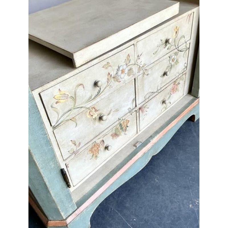 Cette exquise armoire vintage Regency, datant du milieu du XXe siècle, témoigne d'un savoir-faire intemporel et d'un design élégant. Son étonnante finition patinée dans une douce teinte sarcelle, complétée par de délicats motifs chinois peints à la