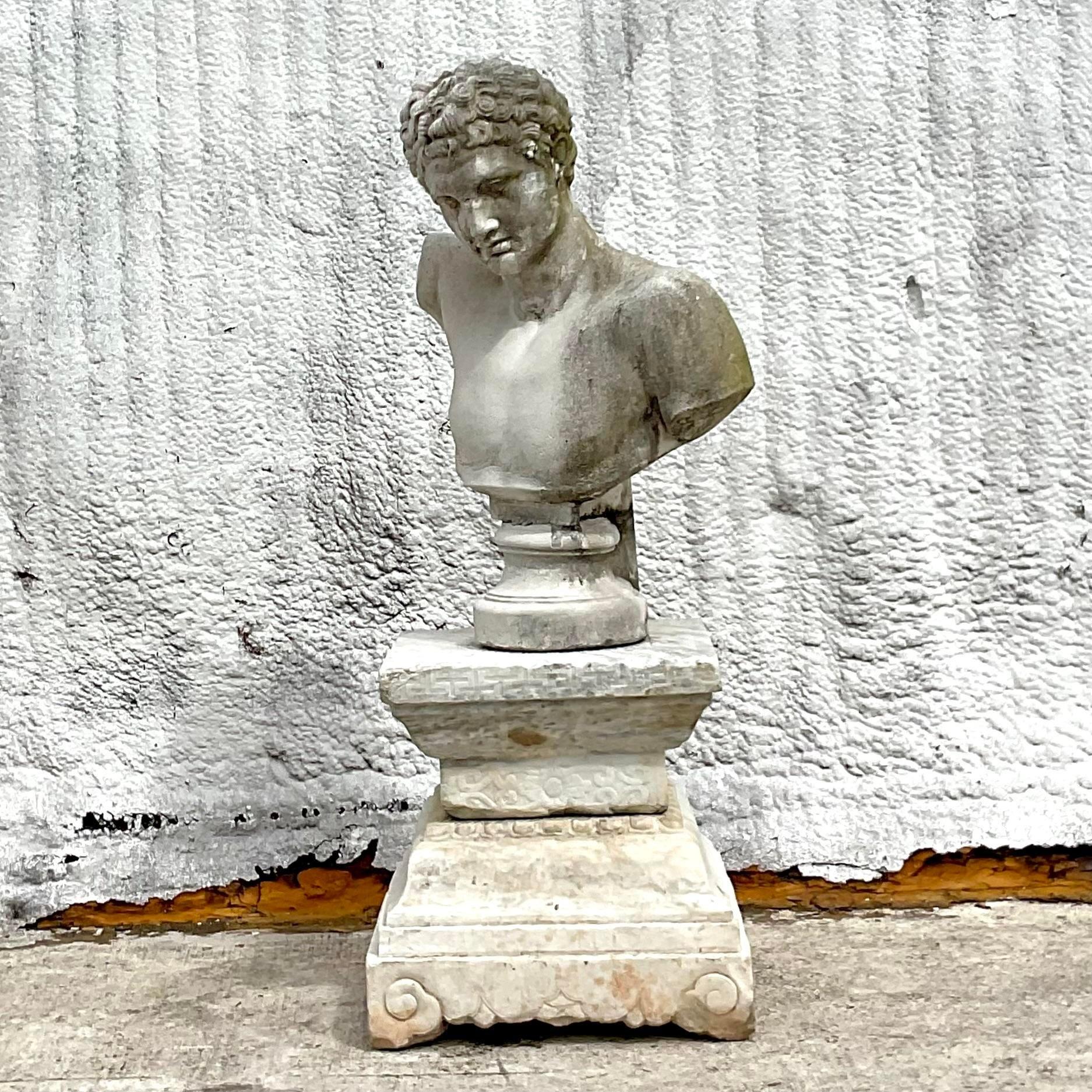 Elevate your space with the timeless elegance of our Vintage Regency Patinated Concrete Bust of Hermes. Crafted with meticulous attention to detail, this striking piece embodies the sophistication of classic American design. With its patinated case