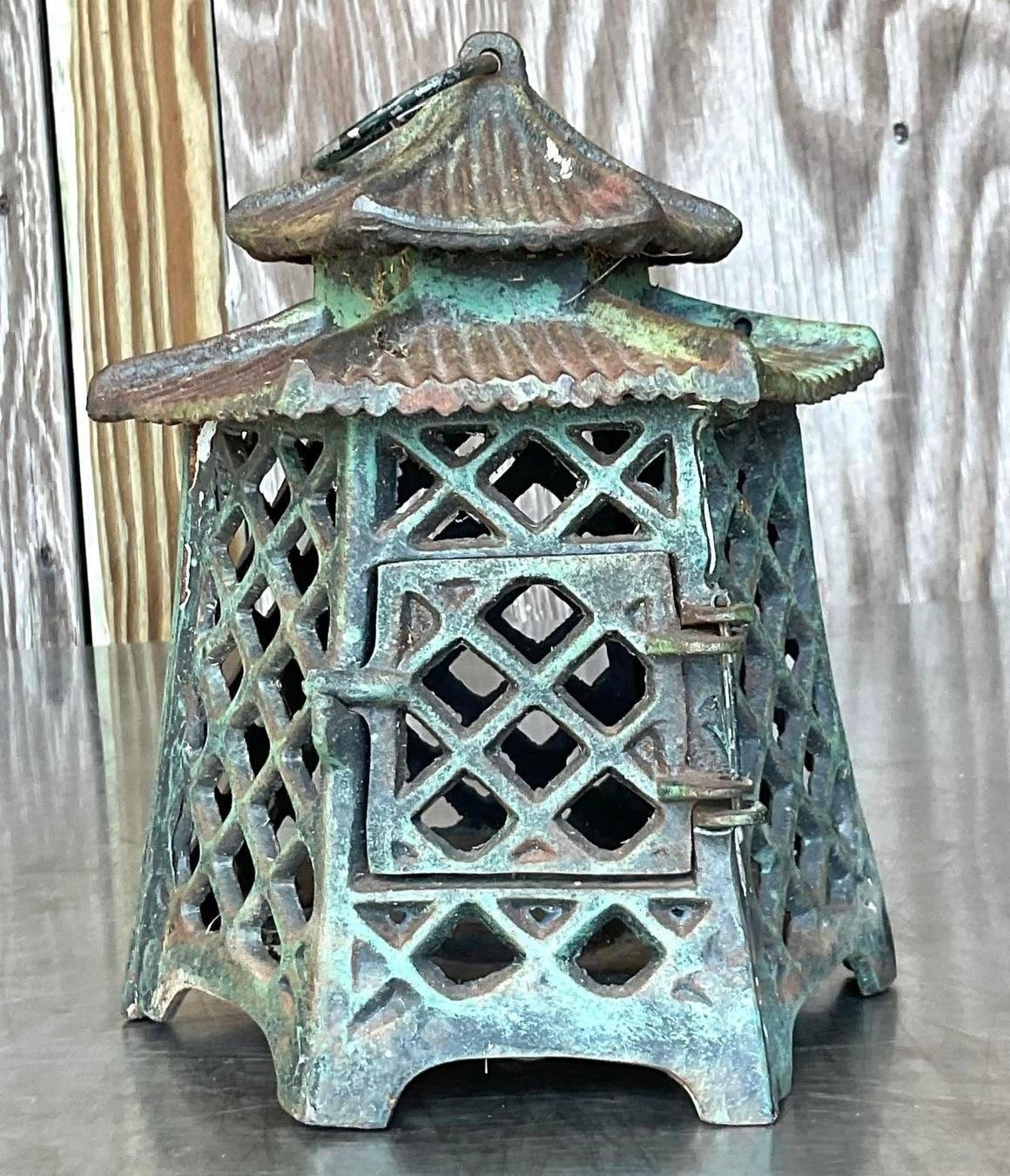 A fantastic vintage Asian lantern. A chic pagoda design in heavy wrought iron. A beautiful patina from time. Acquired from a Palm Beach estate. 