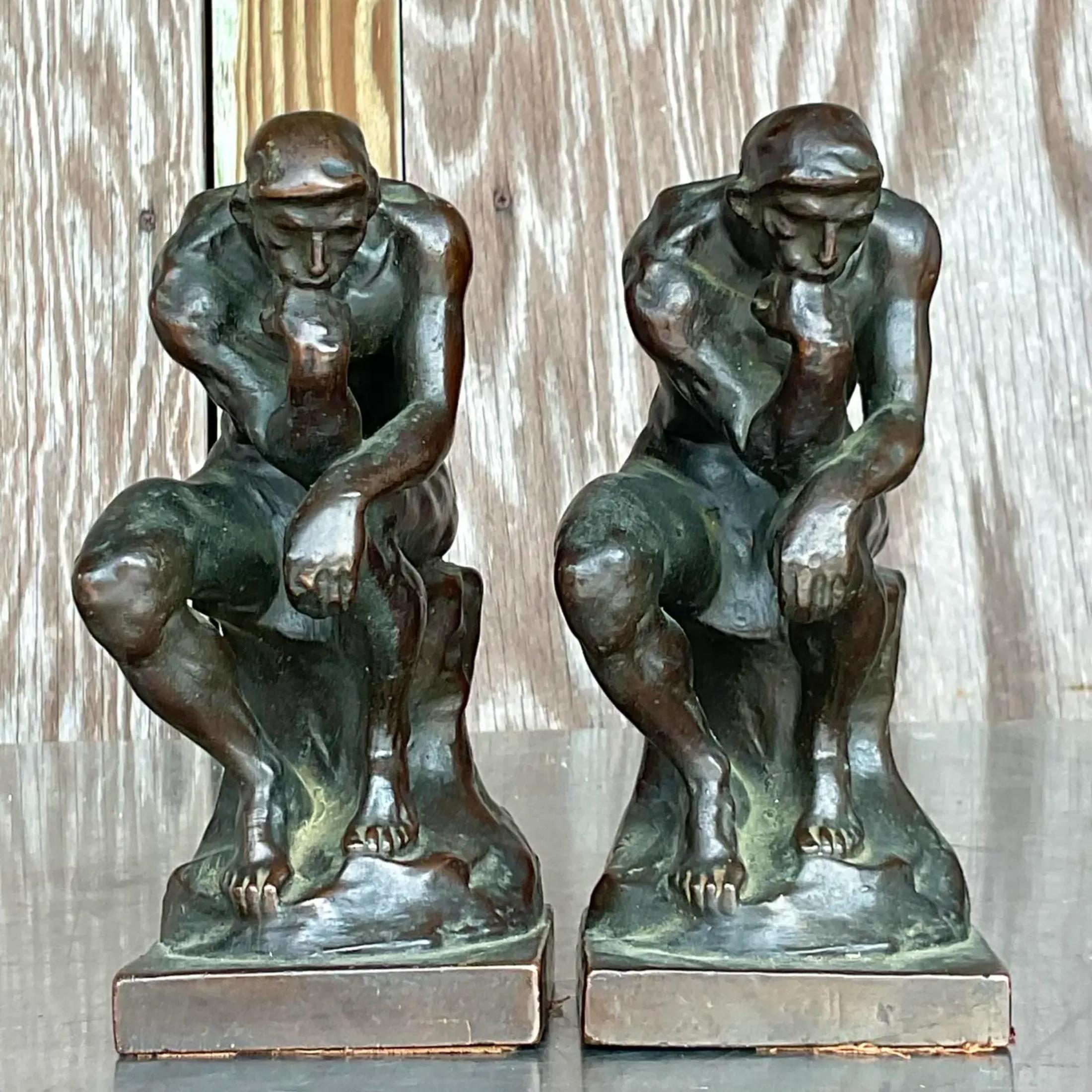 A fantastic pair of vintage Regency bookends. A reproduction of Auguste Robin’s “The Thinker”. A patinated bronze finish over plaster. Marked in back. Acquired from a Miami estate.