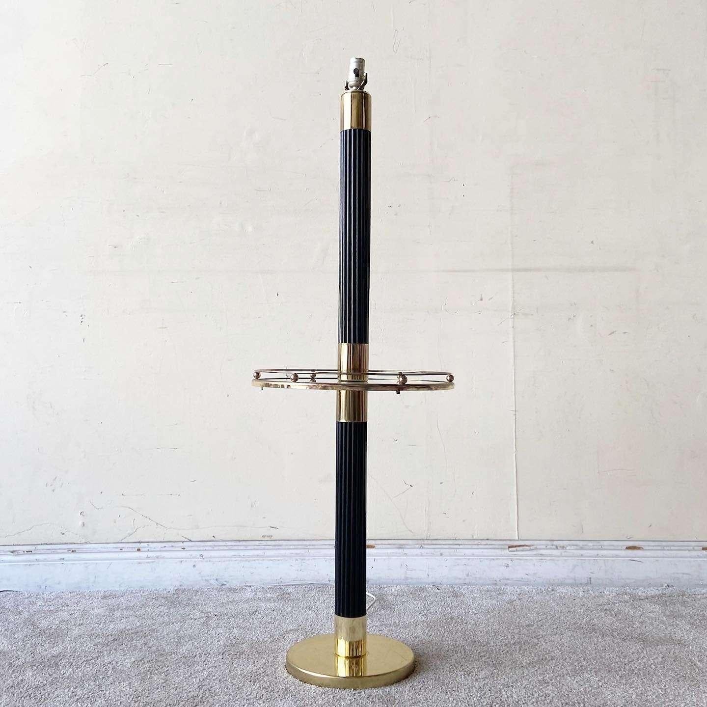 Exceptional vintage Hollywood regency floor lamp/side table combo. Features a pencil reed stem with a glass table with gold framing and accents.