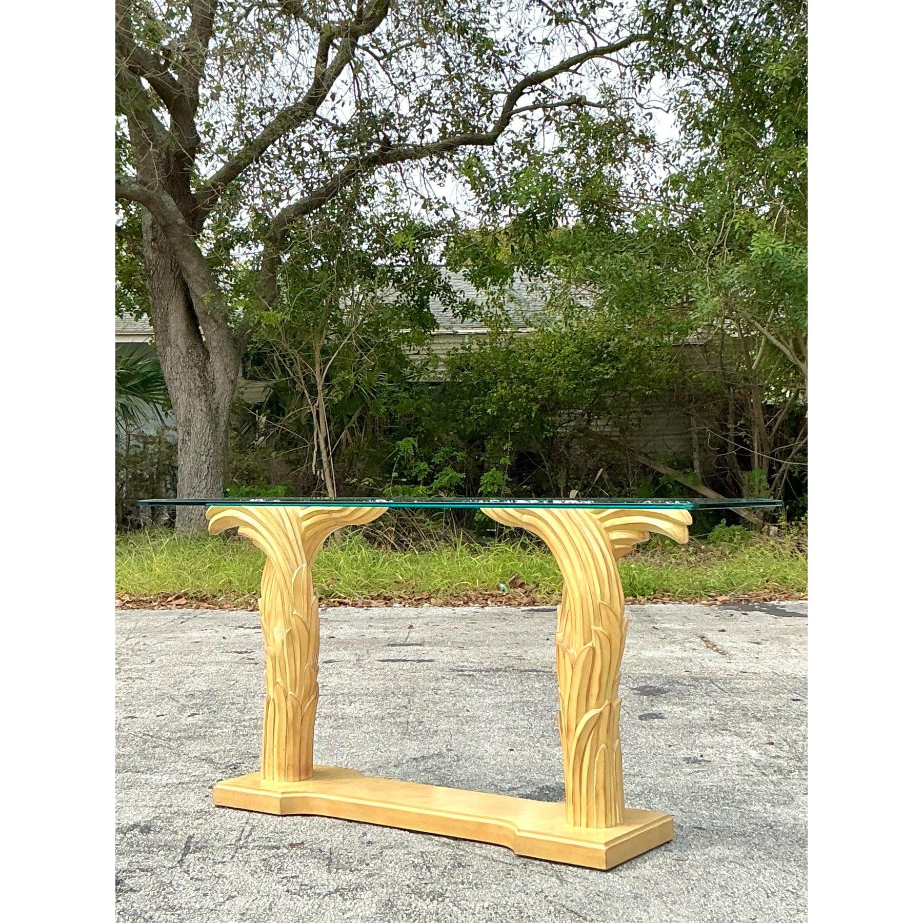 Inspired by the timeless elegance of Serge Roche’s iconic designs, this vintage Regency console table makes a bold statement with its sculptural plaster frond base. The exquisite craftsmanship captures the essence of classic Hollywood Regency style,