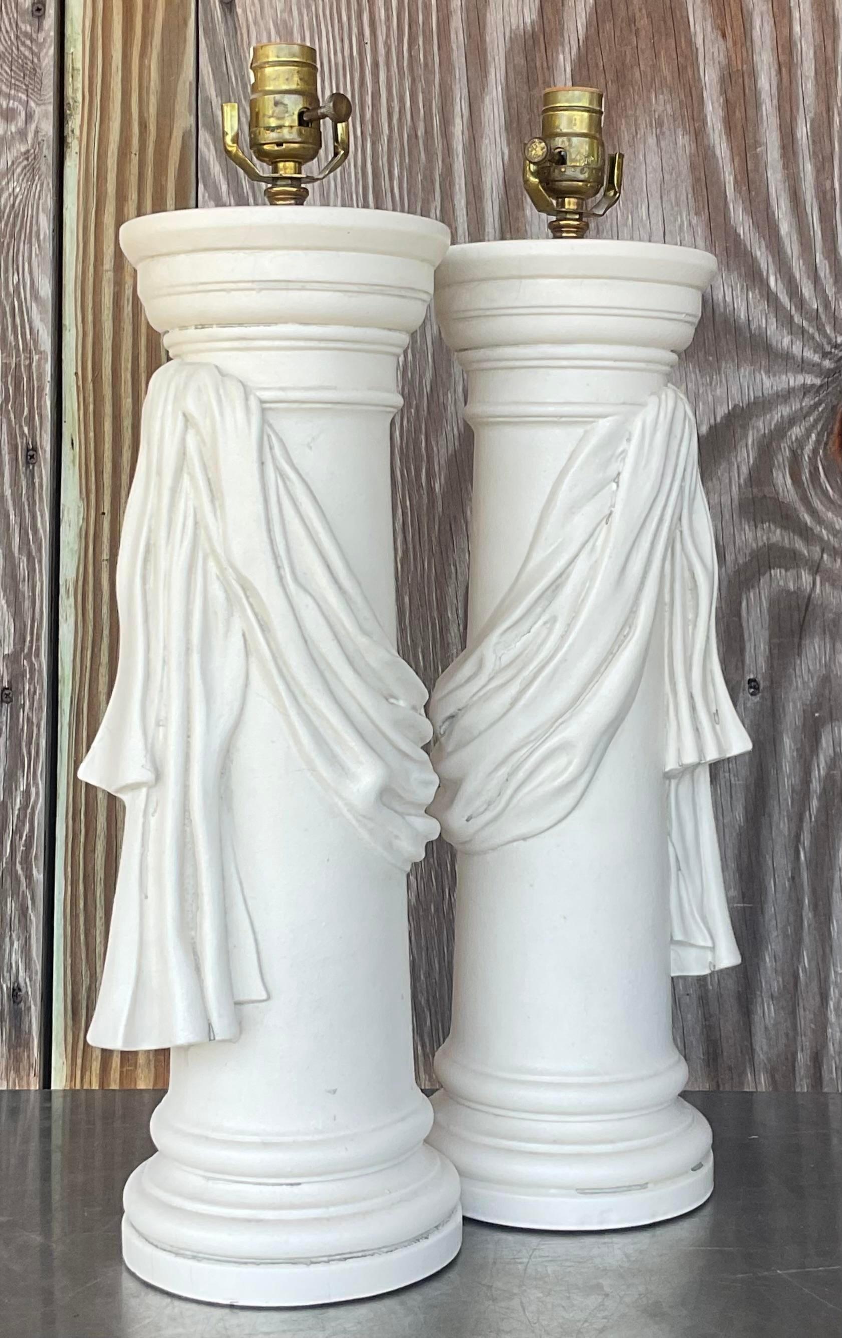 Illuminate your space with vintage charm using this pair of Regency plaster swag lamps. With their classic American design and intricate detailing, they effortlessly blend sophistication and nostalgia, adding a touch of elegance to any room.