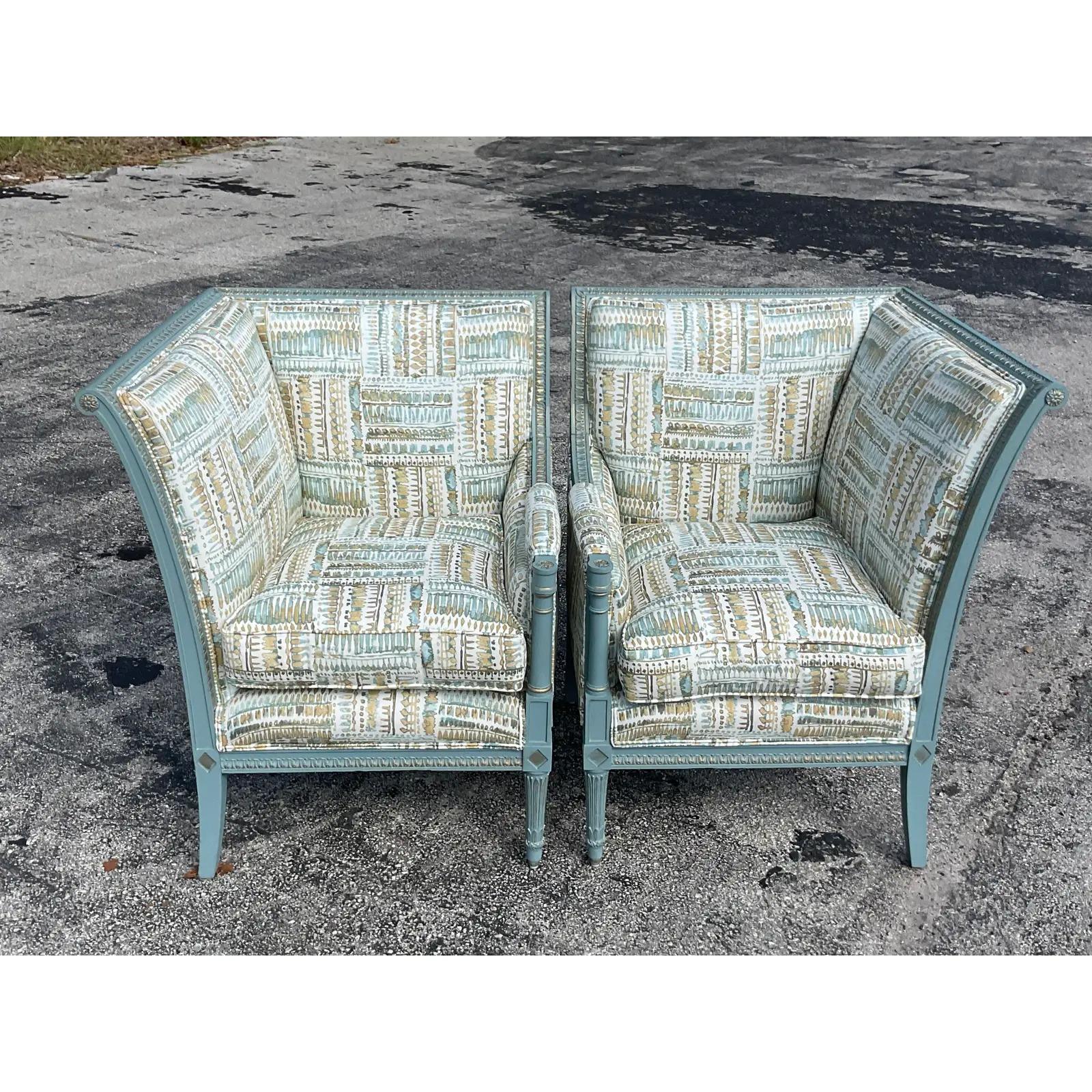 A fantastic pair of regency high back chairs. The pieces are placed together to make a chic little loveseat. Painted wood in the most charming robins Gregg blue with gilt touches. A chic patchwork print on a polished cotton. Down filled seats.