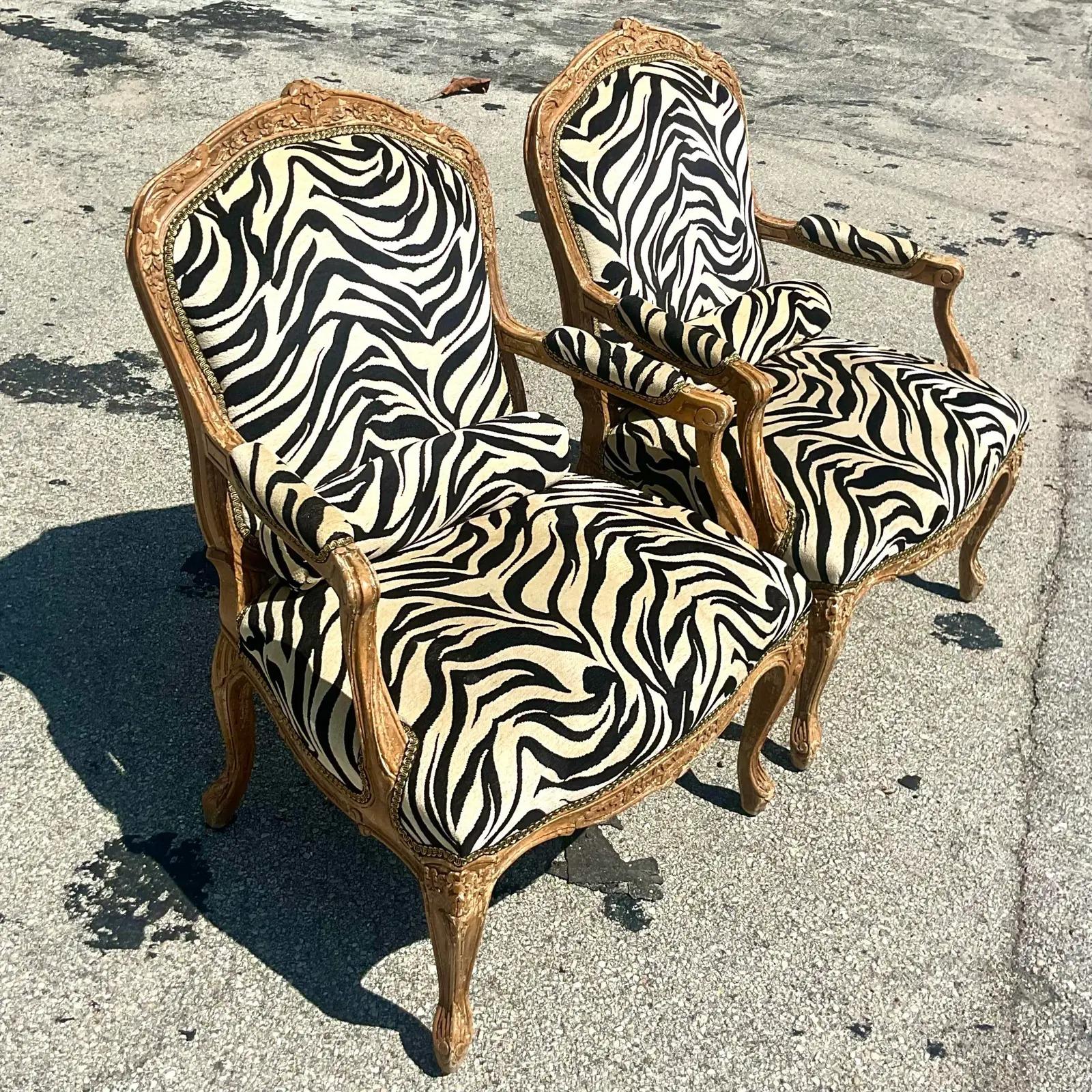 Gorgeous pair of vintage Regency chairs. Beautiful printed zebra on a classic Bergere shape. Beautiful carved wood detail. Acquired from a Palm Beach estate.

The chairs are in great vintage condition minor scuffs and blemishes appropriate to its