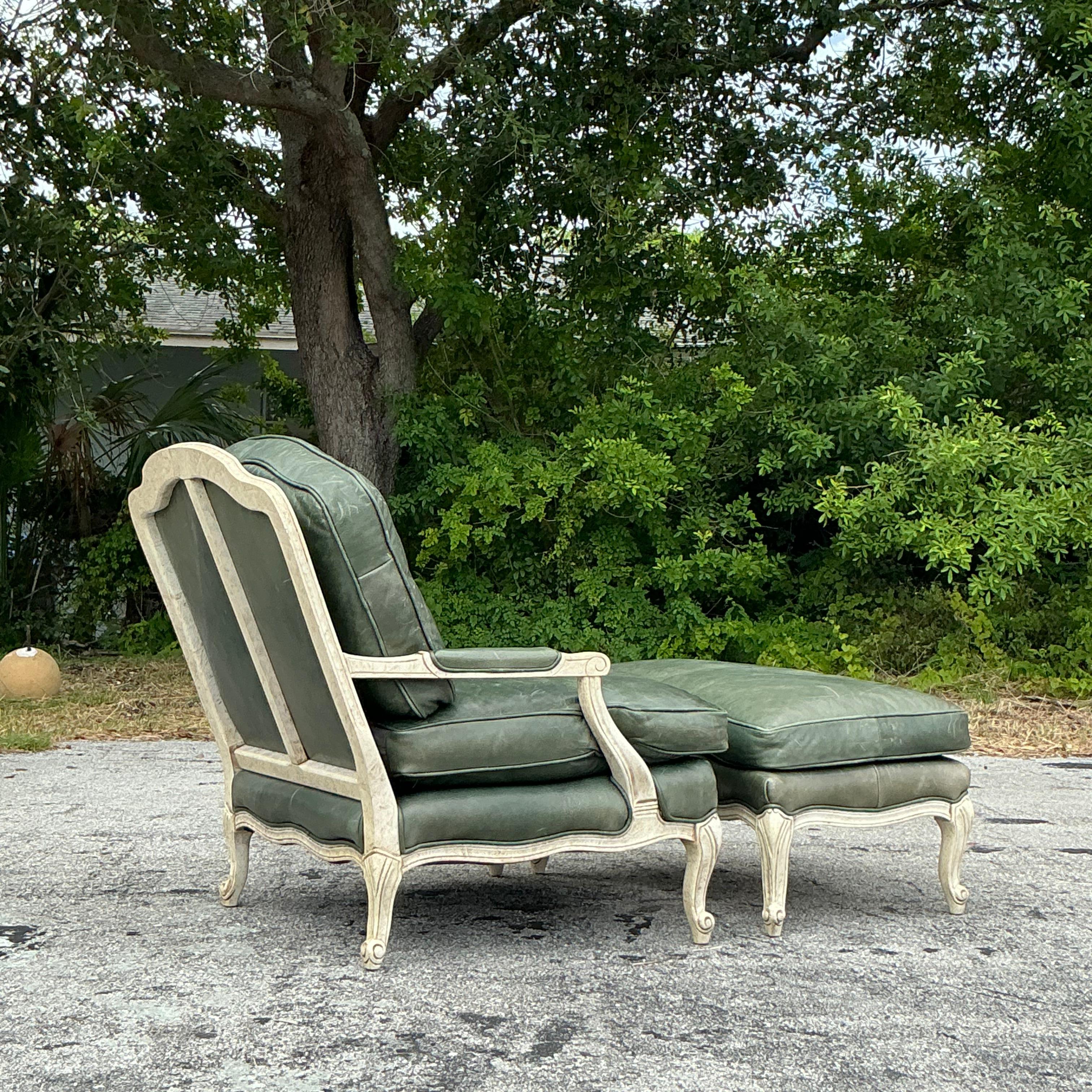Enhance your living area with this Vintage Regency Provincial Green Leather Lounge Chair and Ottoman. Combining American style with Regency flair, this set features rich green leather upholstery and classic provincial details, offering both comfort