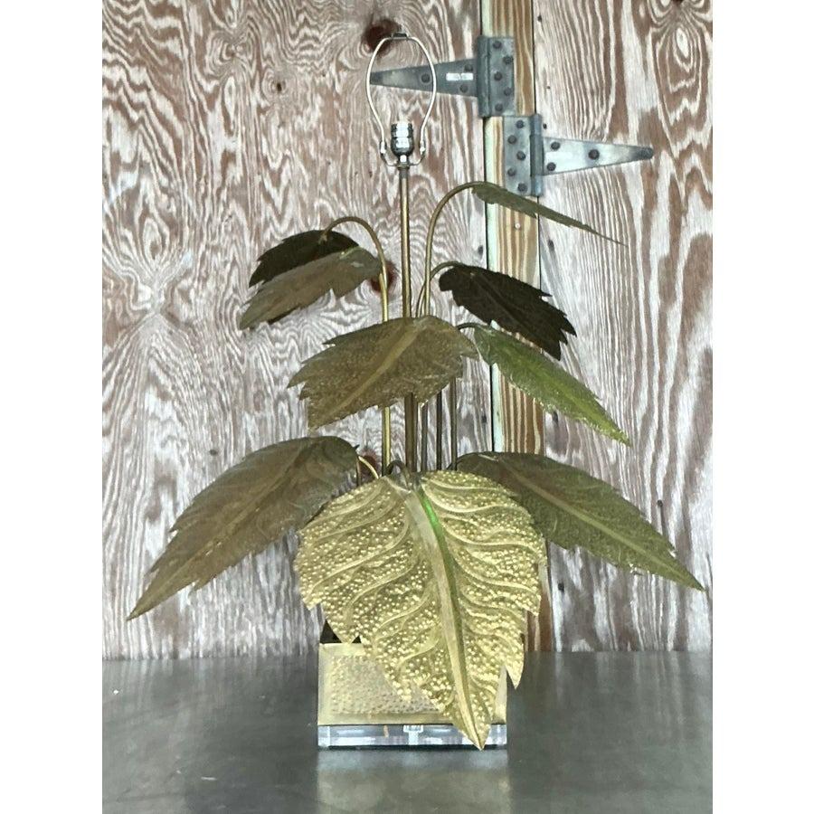 Illuminate your space with the opulent charm of this vintage Regency punch-cut brass leaves lamp. Featuring intricately crafted brass leaves with detailed punch-cut designs, this lamp radiates elegance and timeless sophistication. The warm brass