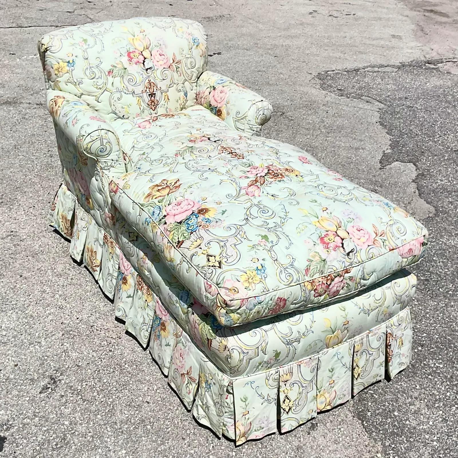 A stunning vintage Regency chaise lounge. A beautiful quilted floral design in pale cool colors. A chic box pleat trim along the bottom.