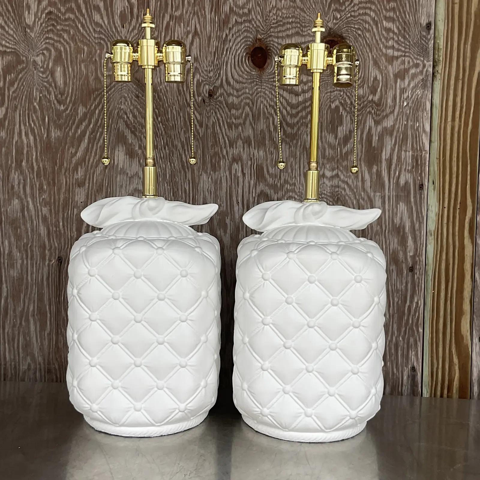 A fabulous pair of vintage table lamps. Chic plaster body with a chic quilted design. Tie detail at the top. Fully restored with all new wiring and hardware. Acquired from a Palm Beach estate.