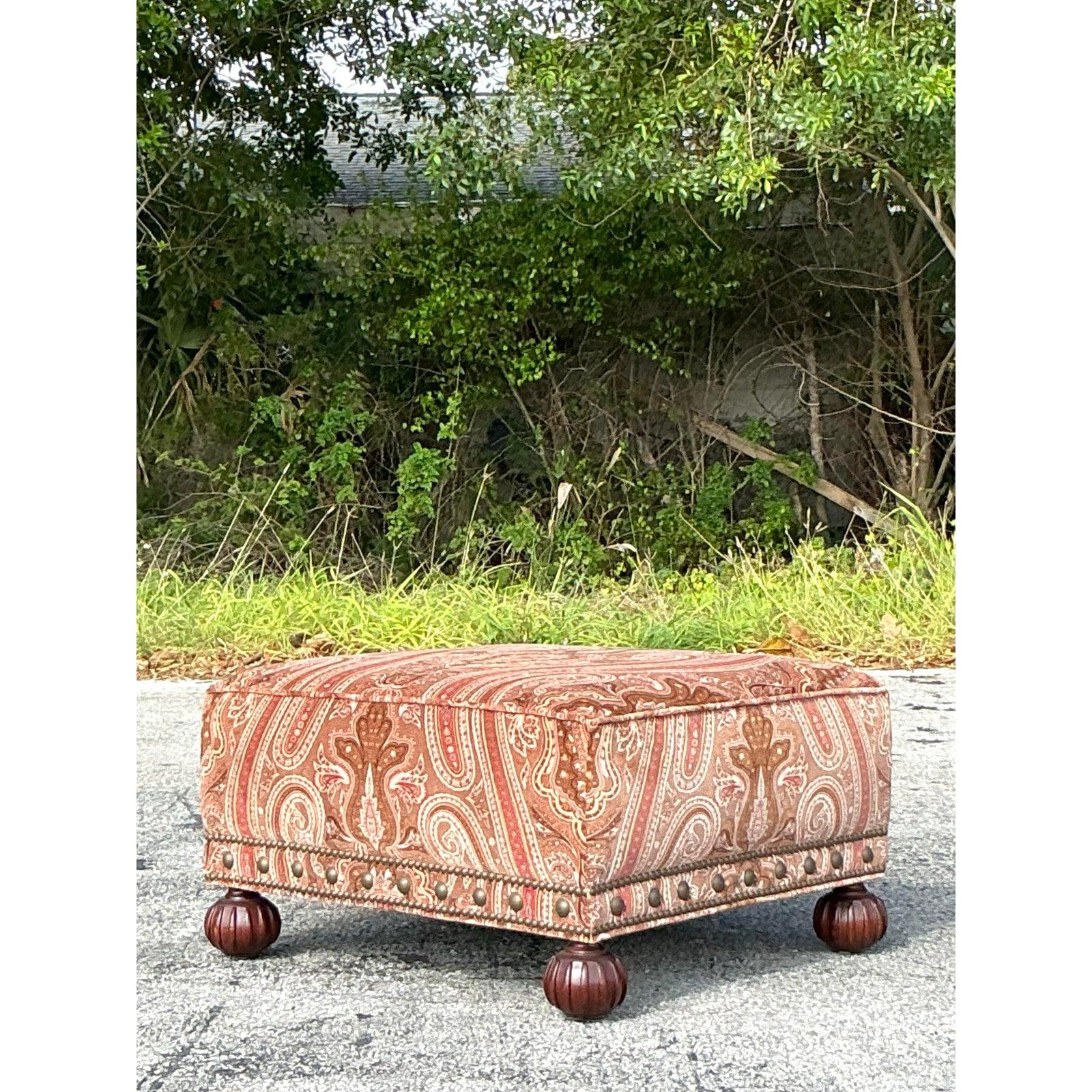 This exquisite vintage Ralph Lauren ottoman blends opulence with classic Regency style. Featuring a luxurious paisley velvet upholstery in warm earthy tones, it exudes elegance and sophistication. The intricate nailhead trim highlights its refined