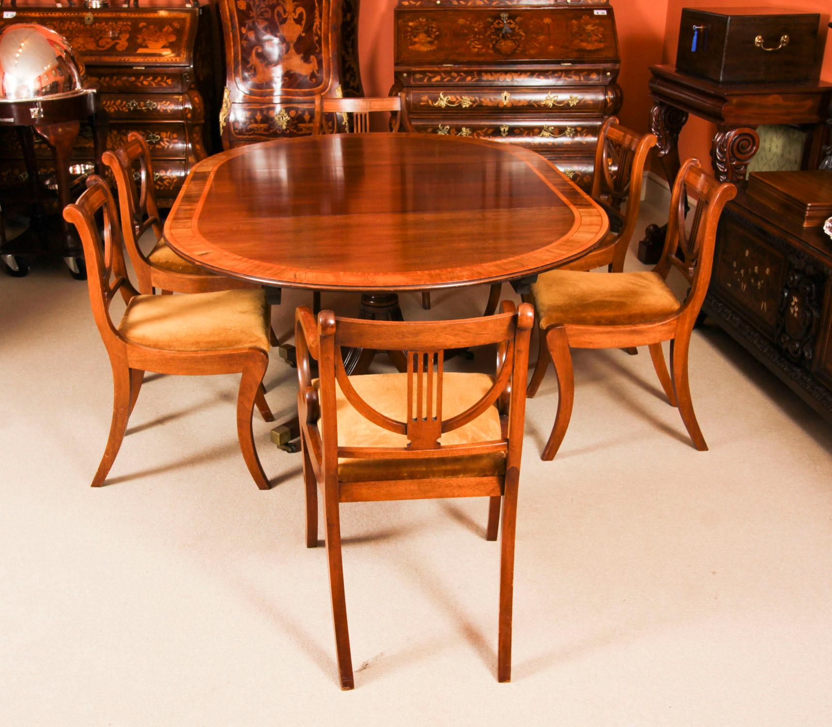 This is a  fabulous vintage dining set which comprises a Regency Revival dining set comprising a dining table & six dining chairs, dating from the second half of the 20th Century.

The beautiful 4ft diameter circular dining table becomes oval when