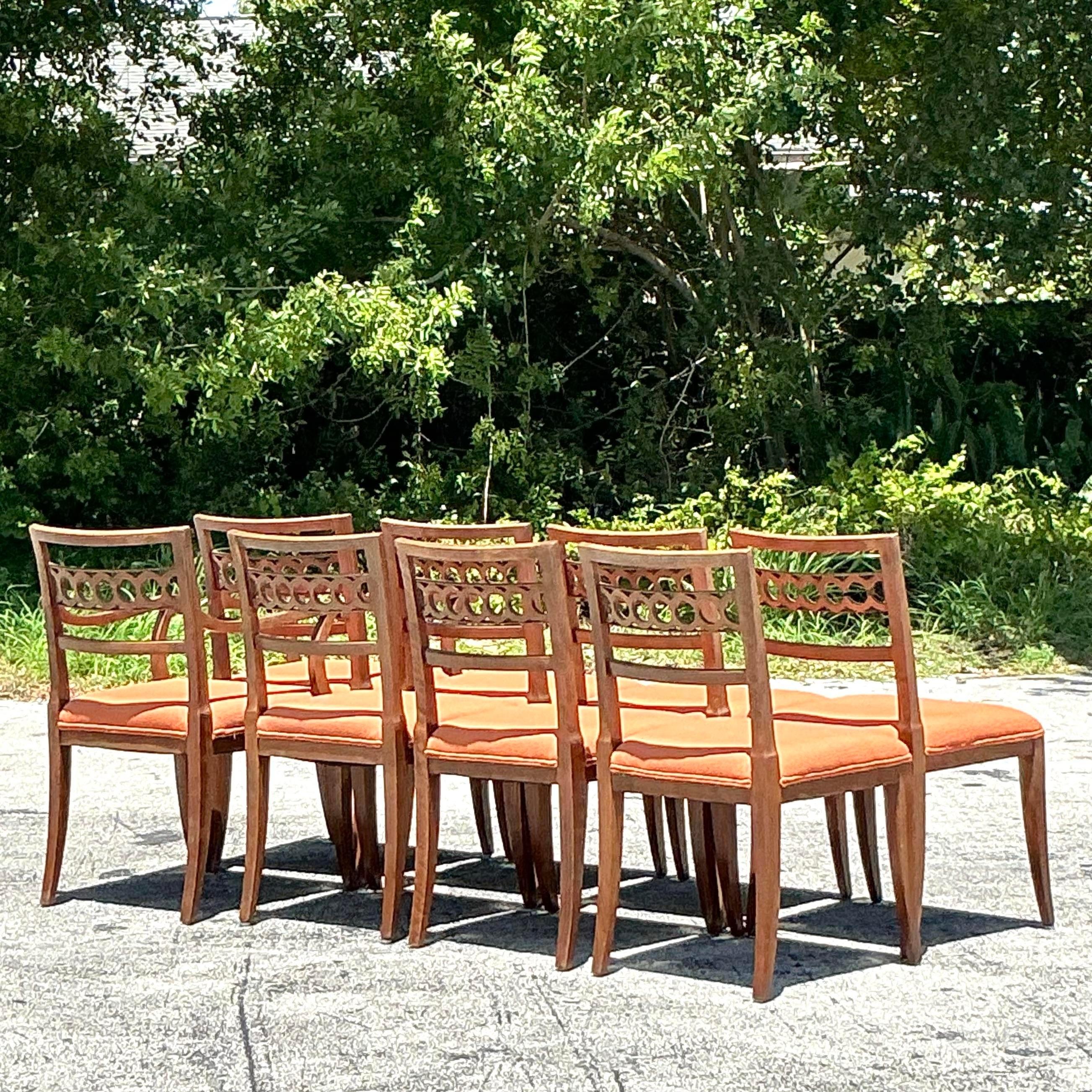 This set of 8 vintage Regency ring back dining chairs exudes classic American charm. Featuring elegant ring back designs and sturdy craftsmanship, these chairs blend timeless style with modern comfort, ideal for enhancing any dining room with a