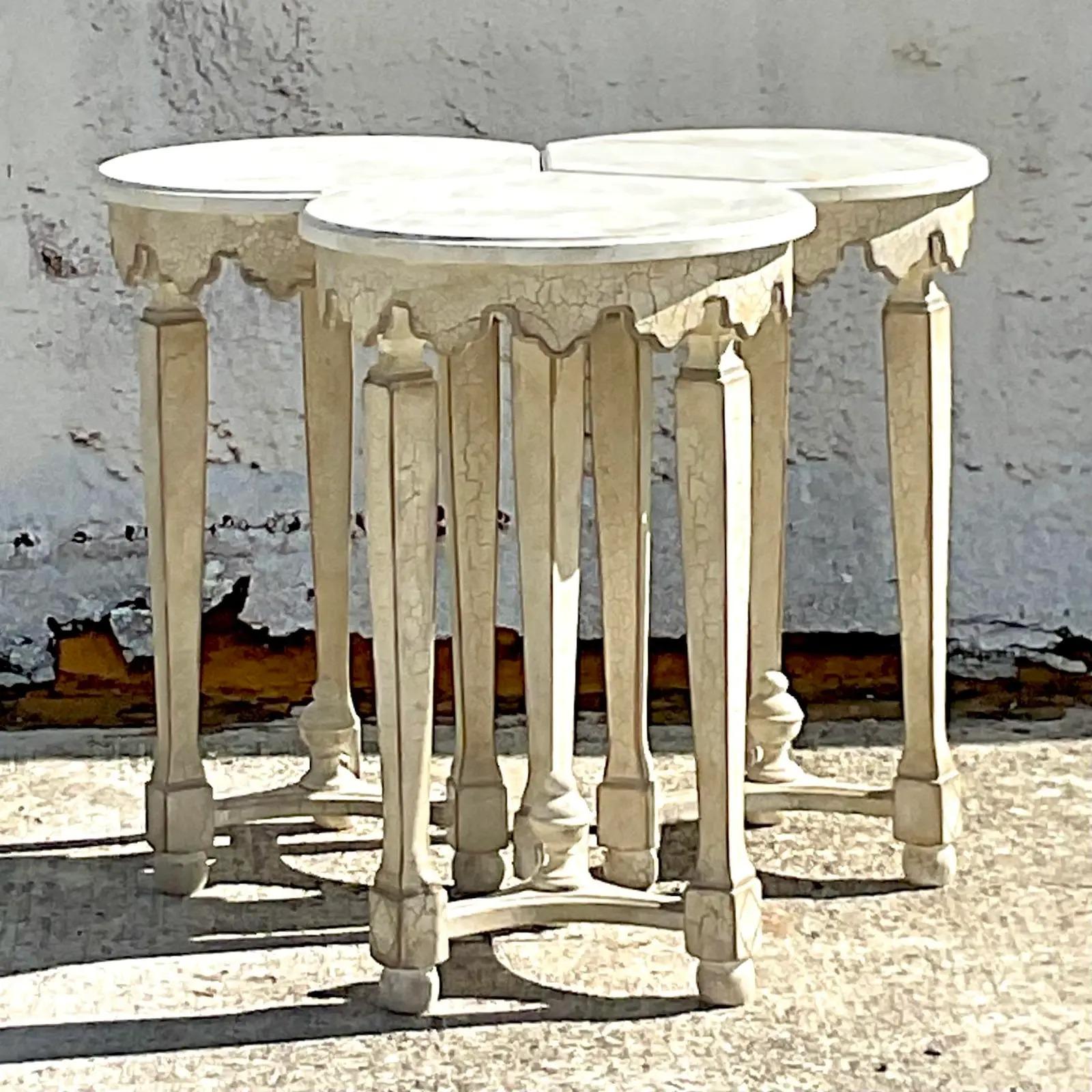 A fantastic set of vintage Regency nesting tables. Beautiful hand painted detail and a charming scalloped edge. The tables sit together as one and then are easily moved apart to make three separate drinks tables. Great for entertaining! Two sets