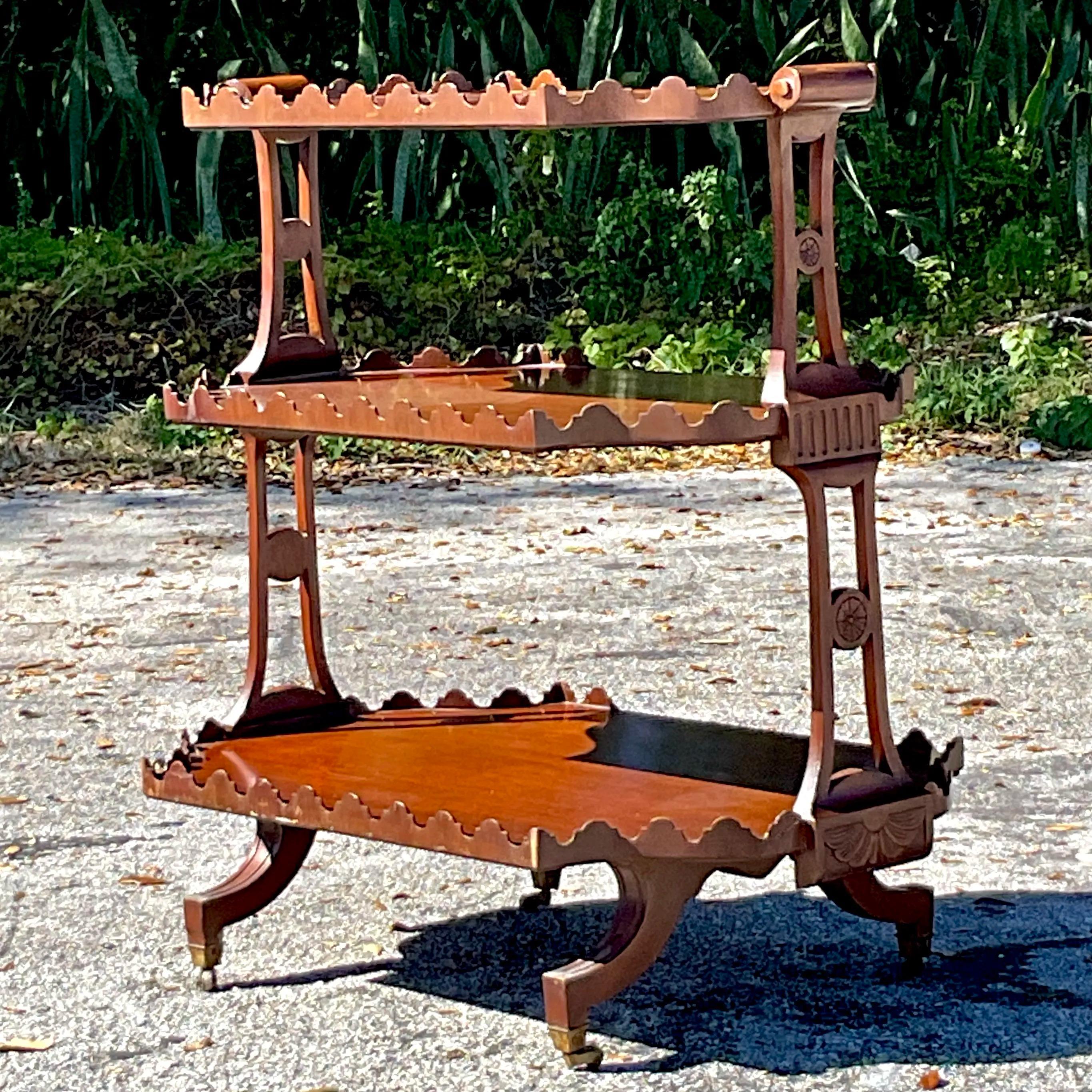 A charming Vintage Regency tiered tray featuring a scalloped butler's design with multiple tiers for display or serving. Its elegant craftsmanship and timeless appeal make it a perfect addition to any entertaining space or decorative collection.