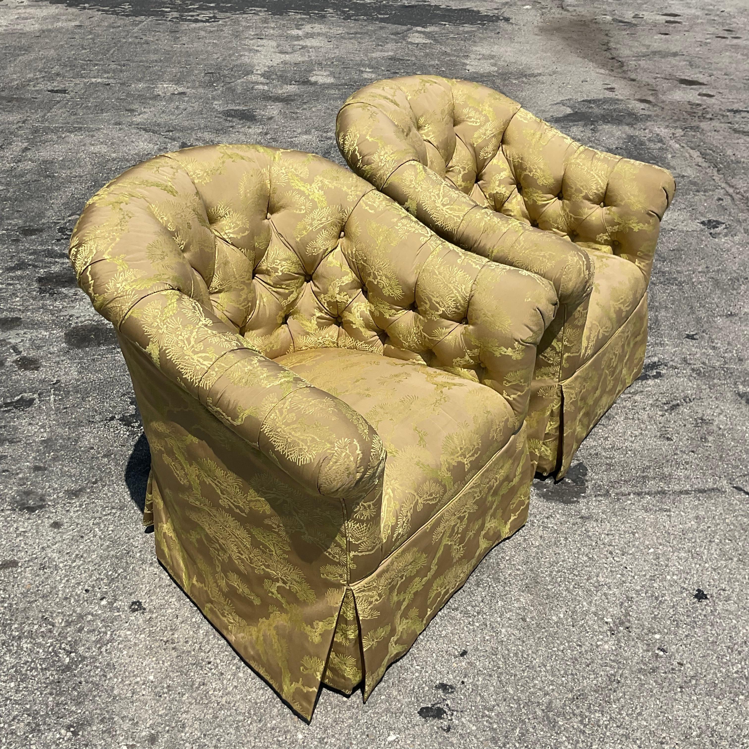 An extraordinary pair of vintage Regency swivel chairs. Chic silk chinoiserie in a brilliant Chartreuse green. Tufted interior and high back makes these chairs a glamorous addition to any space. Acquired from a Palm Beach estate.