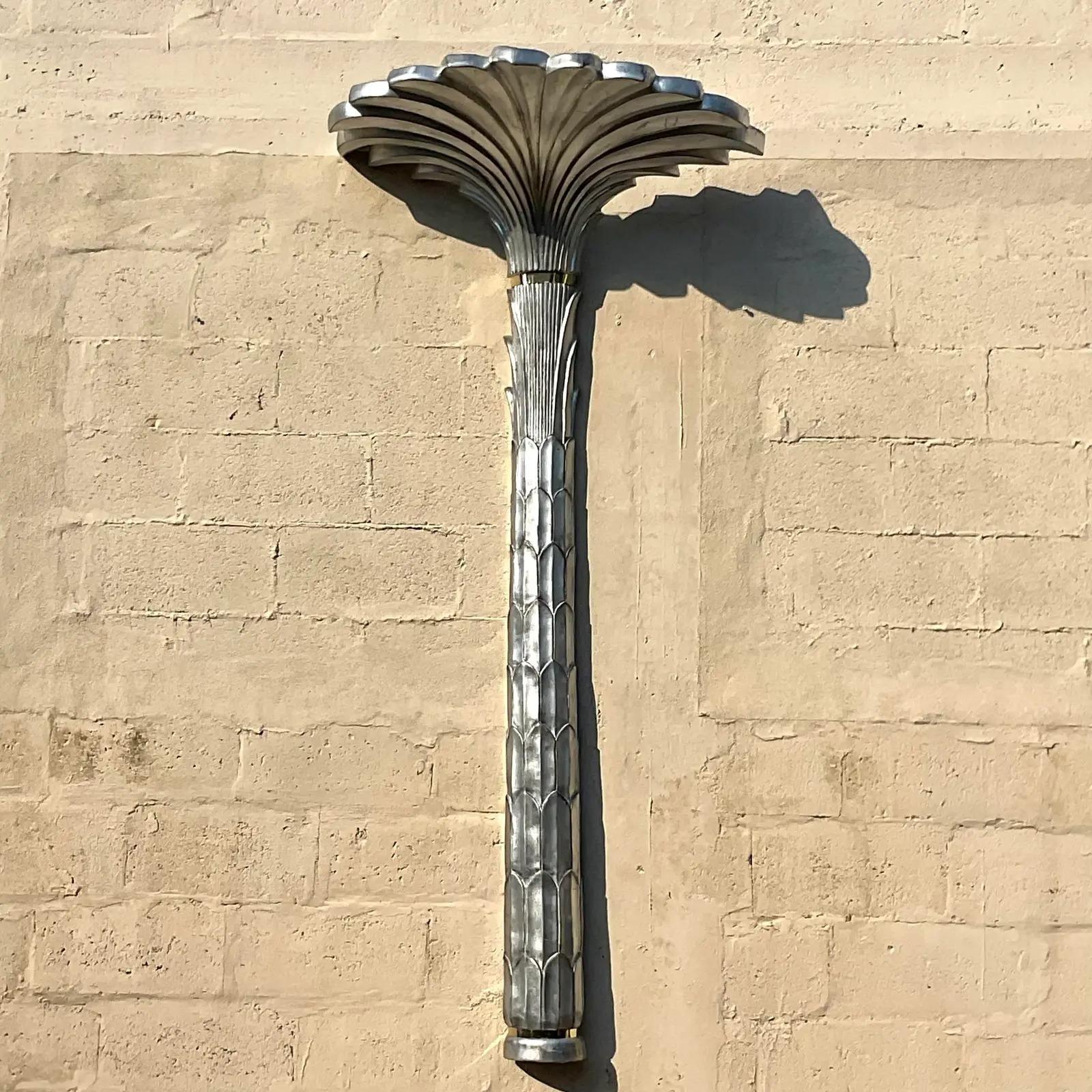 A spectacular vintage Regency wall lamp. A chic silver leaf life size palm tree with brass bands. Perfect as is or change to bright white for a classic Dorothy Draper look. You decide! Acquired from a Palm Beach estate.