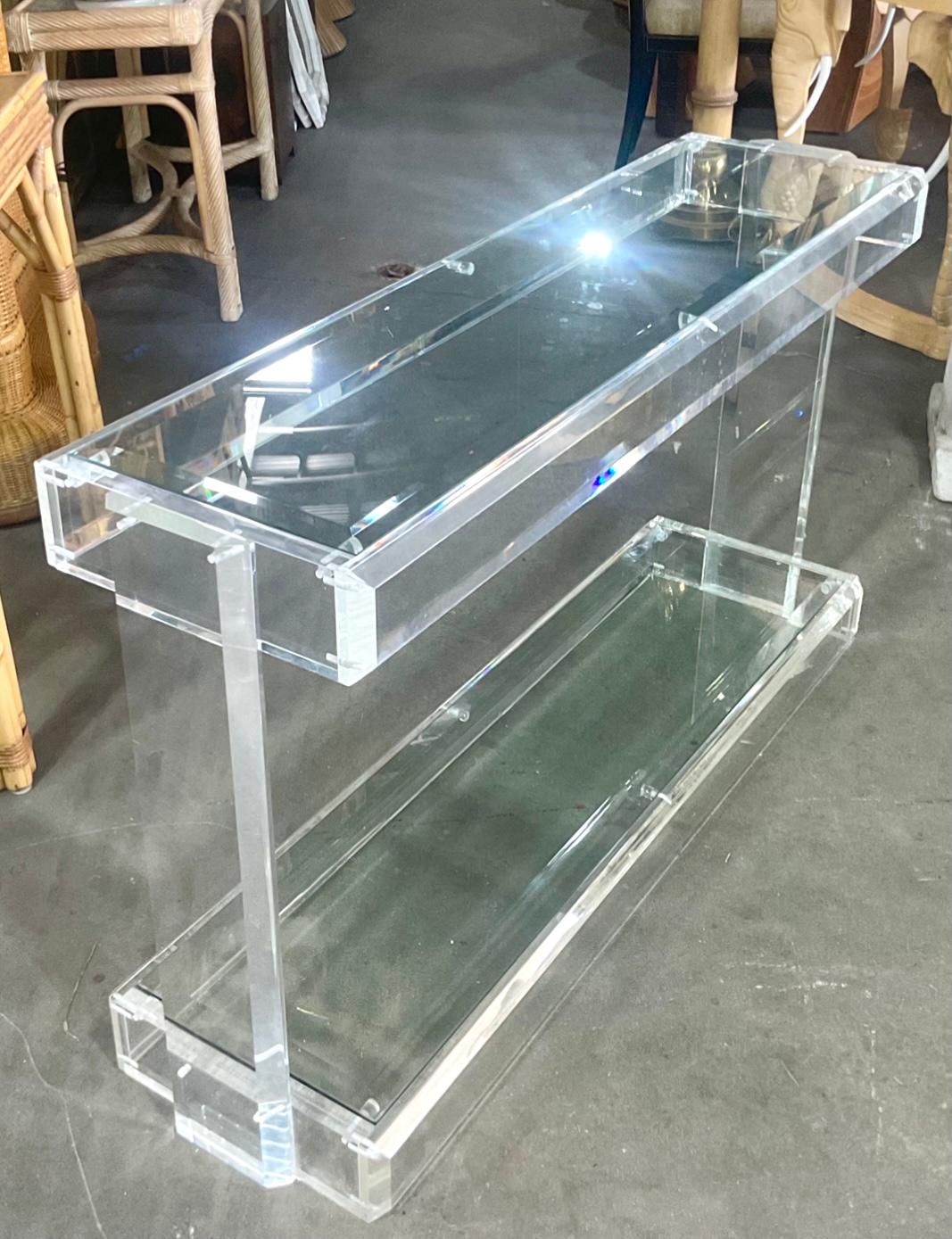 Gorgeous vintage Contemporary Console Table. Beautiful thick sheets of slab lucite are used to create this striking console. Diamond cut with lots of reflective facets. Acquired from Palm Beach estate.