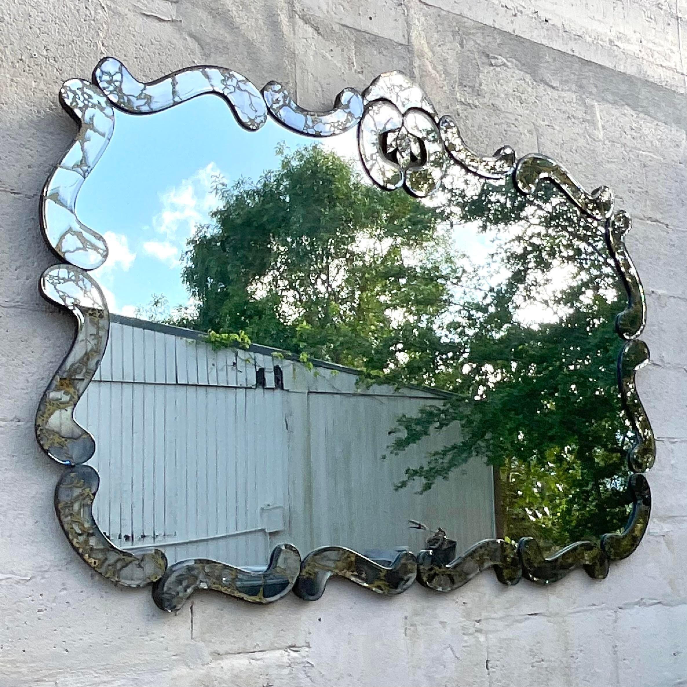 Indulge in classic elegance with this vintage Regency Smoked Glass Mirror, an emblem of American refinement and sophistication. The smoked glass exudes timeless allure, while its Regency-inspired design adds a touch of grandeur to any space, making