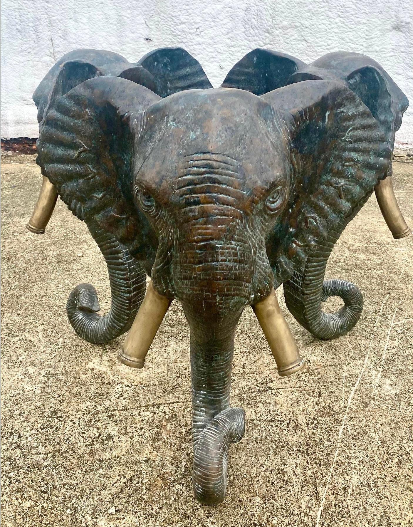 Incredible vintage Regency elephant center table pedestal. Solid bronze with striking sculpted detail. Brass capped tusks. Can be used as a side table or a center table. Acquired from a Palm Beach estate.