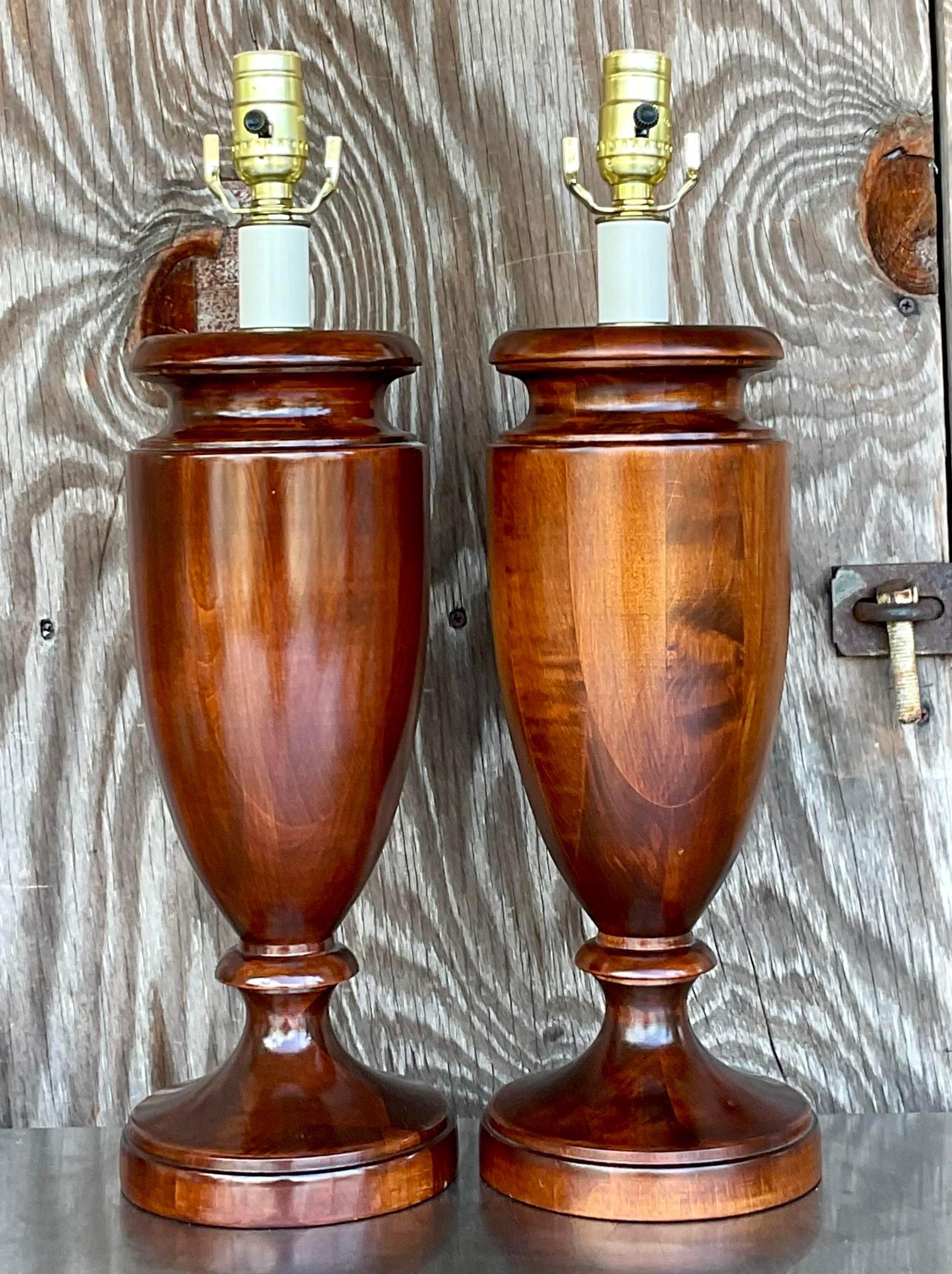 A fabulous pair of vintage Regency table lamps. Gorgeous wood turned lamps in an urn design. Beautiful wood grain detail. Acquired from a Palm Beach estate.