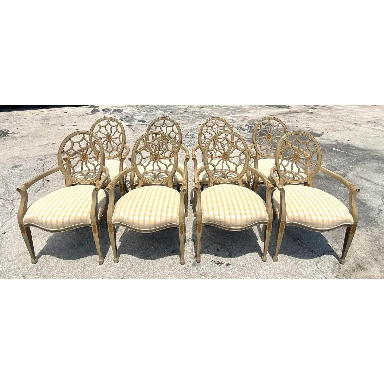 Gorgeous set of 8 vintage Regency dining chairs. Beautiful spider back design with chic striped upholstery. A gorgeous addition to any room. Acquired from a Palm Beach estate.