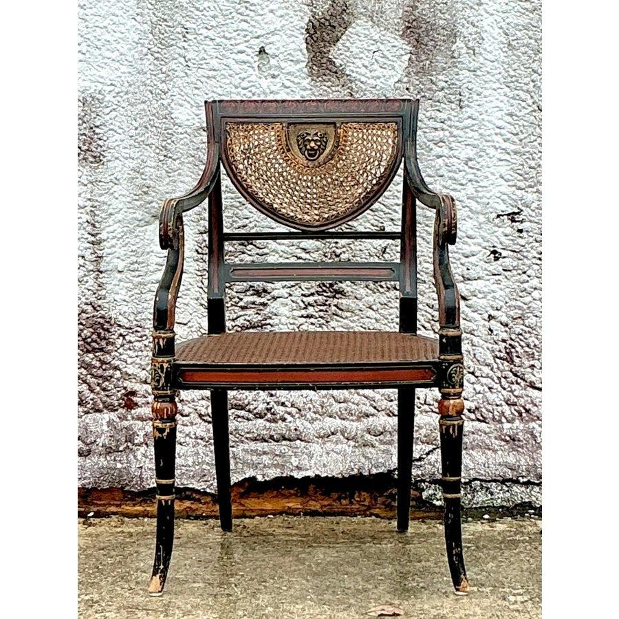 Introduce timeless elegance to your seating with this vintage Regency spider web cane armchair. Featuring an intricately crafted spider web back design and handwoven cane detailing, this chair seamlessly blends artistry with comfort. The gracefully