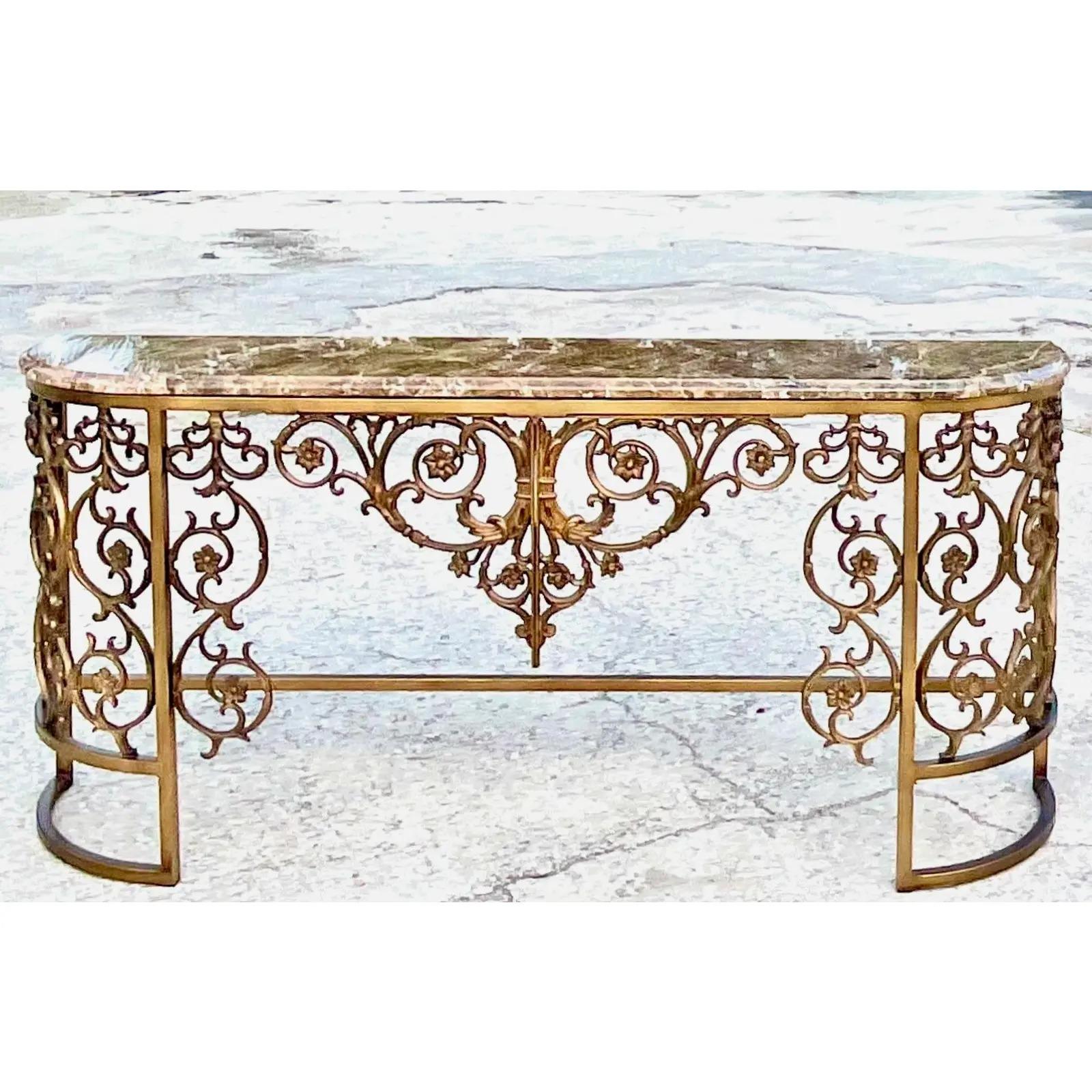 Fantastic vintage Regency console table. Stone top and a matte gilt wrought iron base. A stunning piece. Perfect indoors or in an outside covered area. Acquired from a Palm Beach estate.
