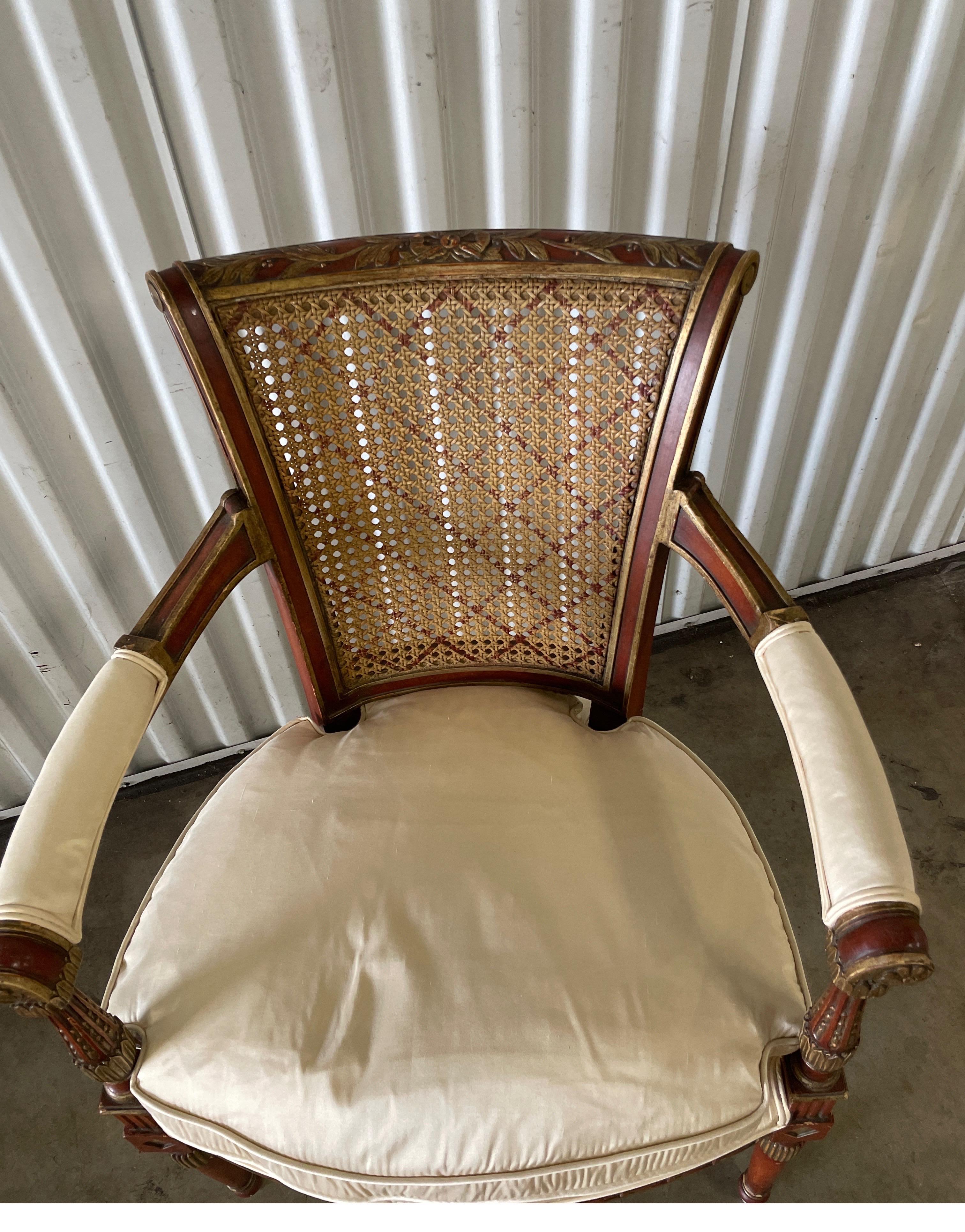 Vintage Regency Style armchair. Cane back with a hand painted lattice motif.
Newly upholstered in bone silk fabric by Scalamandre.