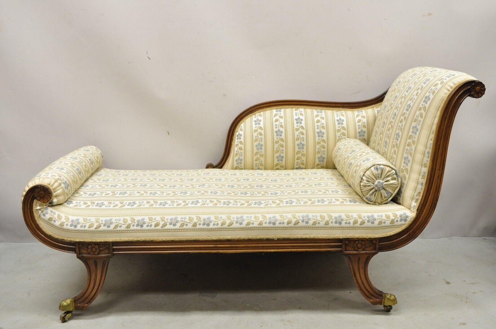 Vintage Regency Style Carved Mahogany Saber Leg Chaise Lounge Sofa Recamier. Item features carved mahogany wood frame, brass capped paw feet on casters, blue and gold striped upholstery, shapely saber legs, very nice vintage item, great style and