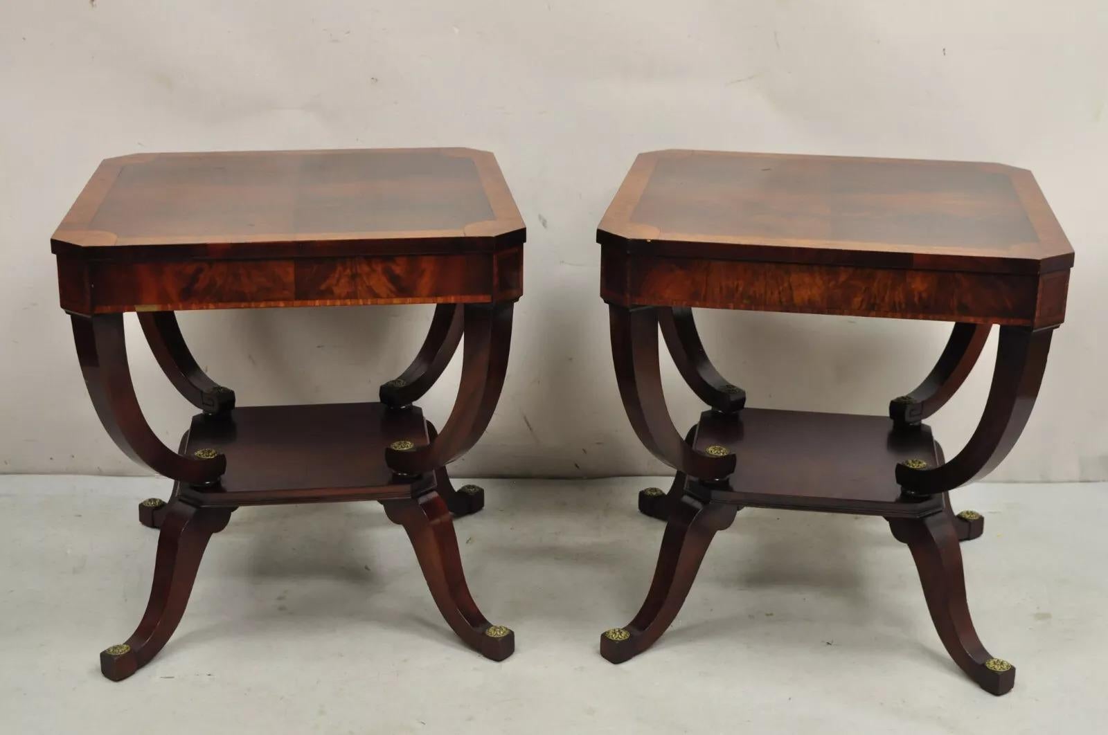 Vintage Regency Style Flamed Mahogany 2 Tier Square End Tables with brass medallions - a Pair. Circa Mid 20th Century. Measurements: 24.75