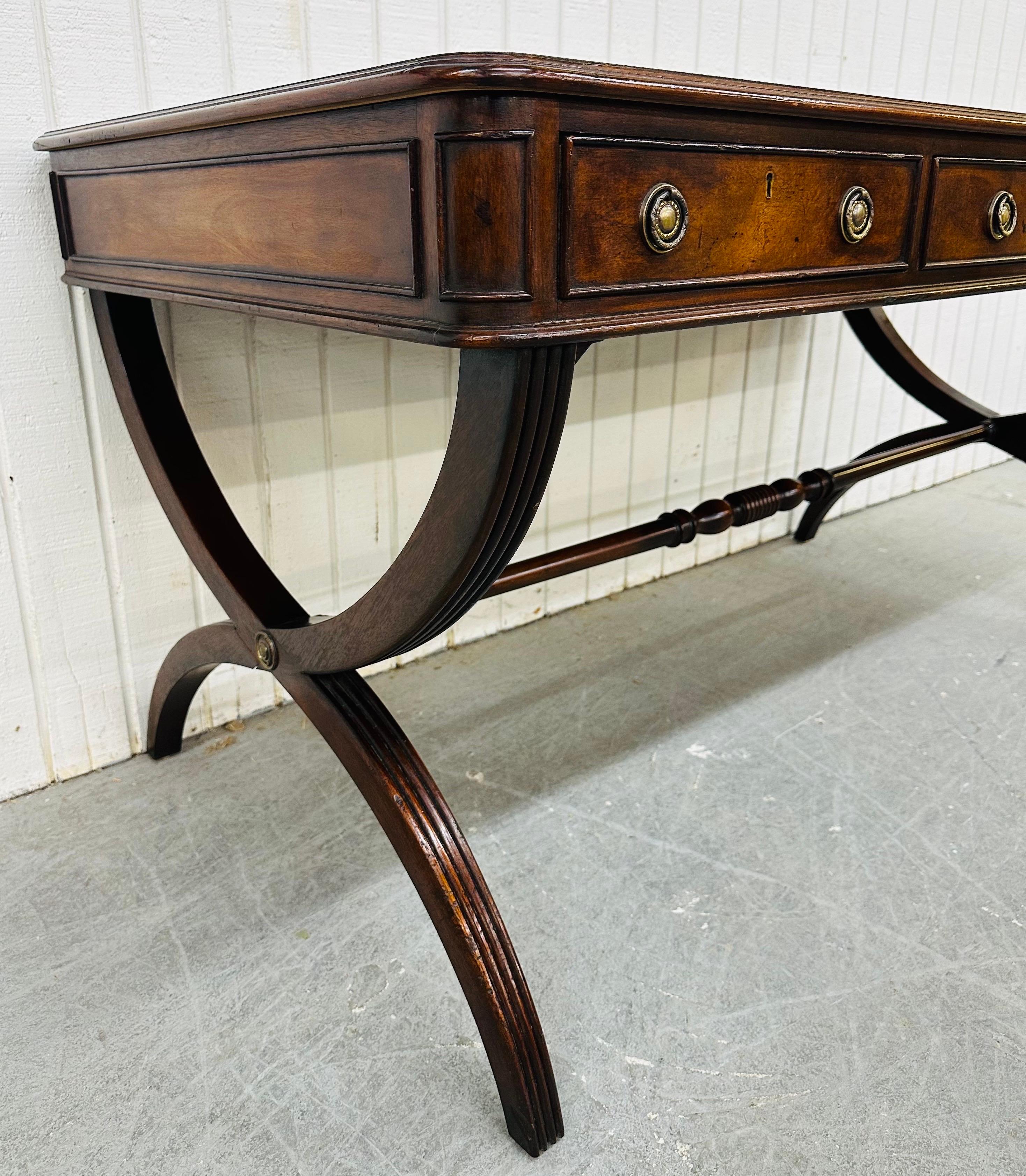 This listing is for a Vintage Regency Style Leather Top Walnut Partners Desk. Featuring a Regency style design, rectangular leather top, three drawers with lock for storage, crisscross legs, and finished backside. This is an exceptional combination