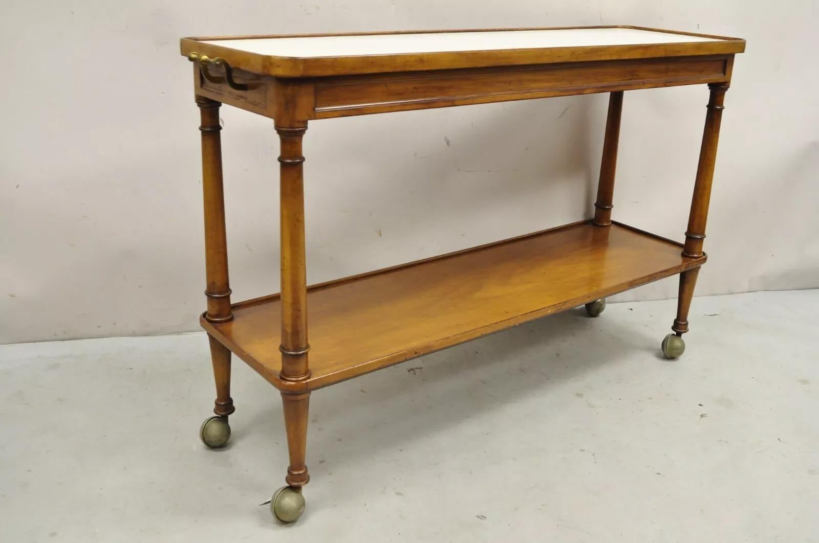 Vintage Regency Style Mahogany 2 Tier Rolling Server Narrow Bar Cart by Hadleigh. Item features a beige laminate top, rolling casters, brass handles, great style and form. Circa Mid 20th Century. Measurements: 30.5