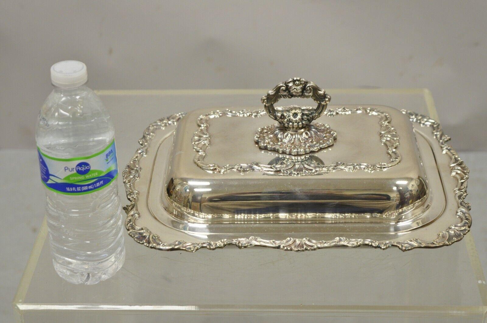 Vintage Regency Style silver plated covered vegetable dish serving platter.
Item features an ornate removable handle, 2 interior sections, ornate decoration throughout. Circa Mid 20th Century. Measurements: 5.5