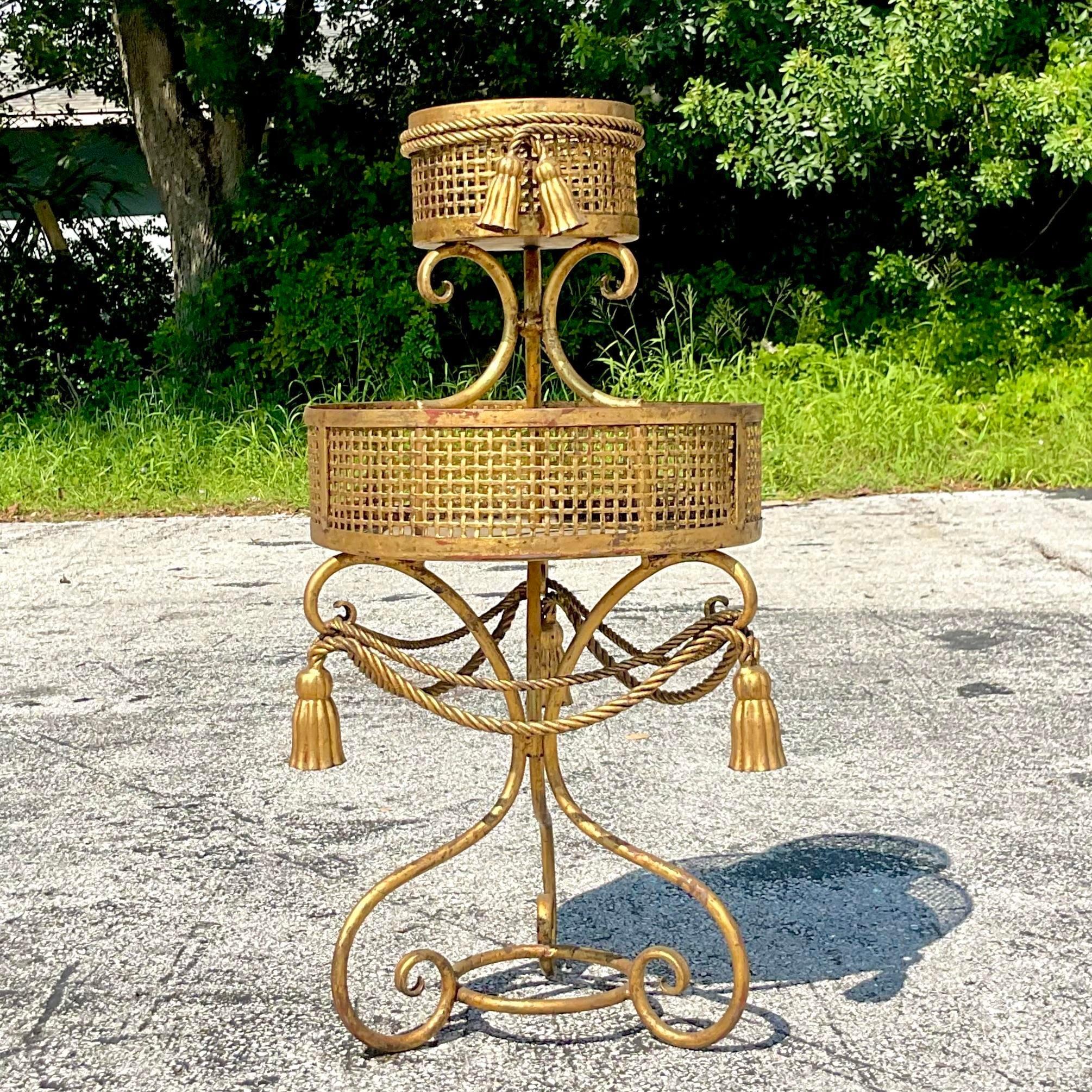 A fabulous vintage Regency plant stand. A chic two tier stand with gorgeous swag detail. Perfect as is or change to black or white to suit your project. Acquired from a Palm Beach estate