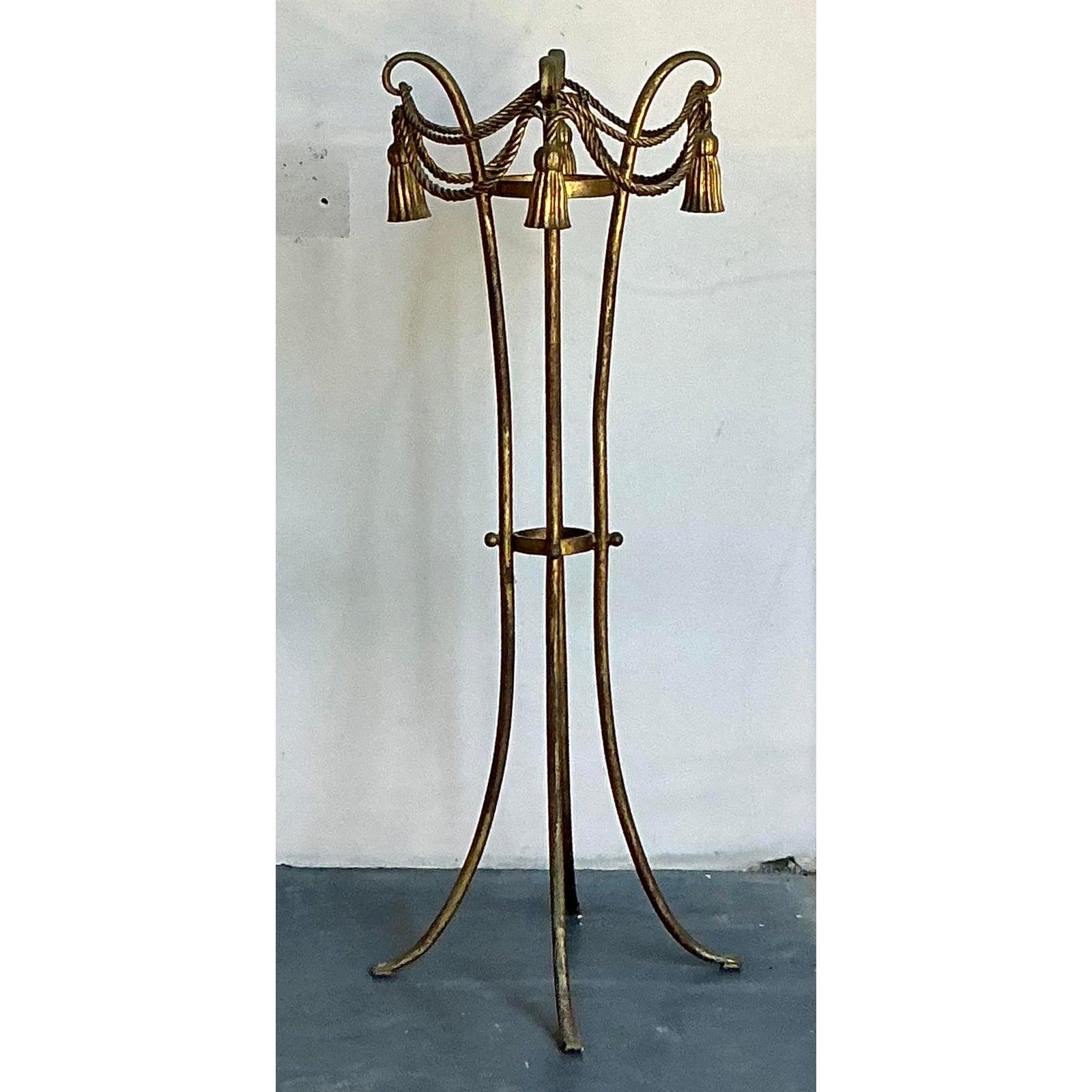 Elevate your indoor or outdoor garden with this enchanting Vintage Regency Tassel and Swag Plant Stand, a piece that embodies sophisticated whimsy and classical elegance. Crafted from a gracefully formed metal with a rich, antique gold finish, this