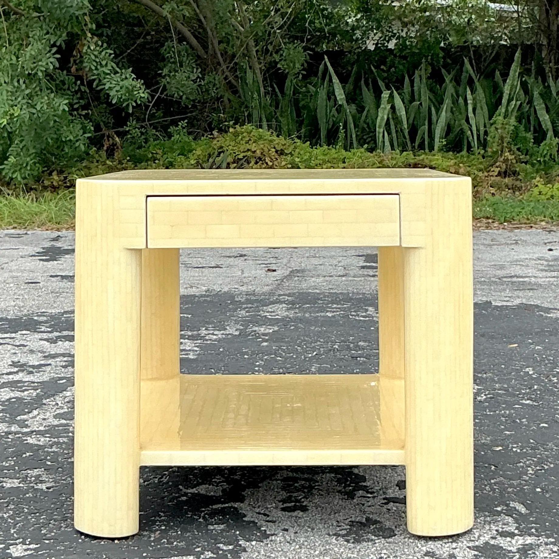 Bring timeless elegance to your space with this Vintage Regency Tessellated Bone Nightstand. Featuring a stunning tessellated bone exterior in a soft, neutral tone, this piece exudes luxury and craftsmanship. Its clean lines and subtle geometric