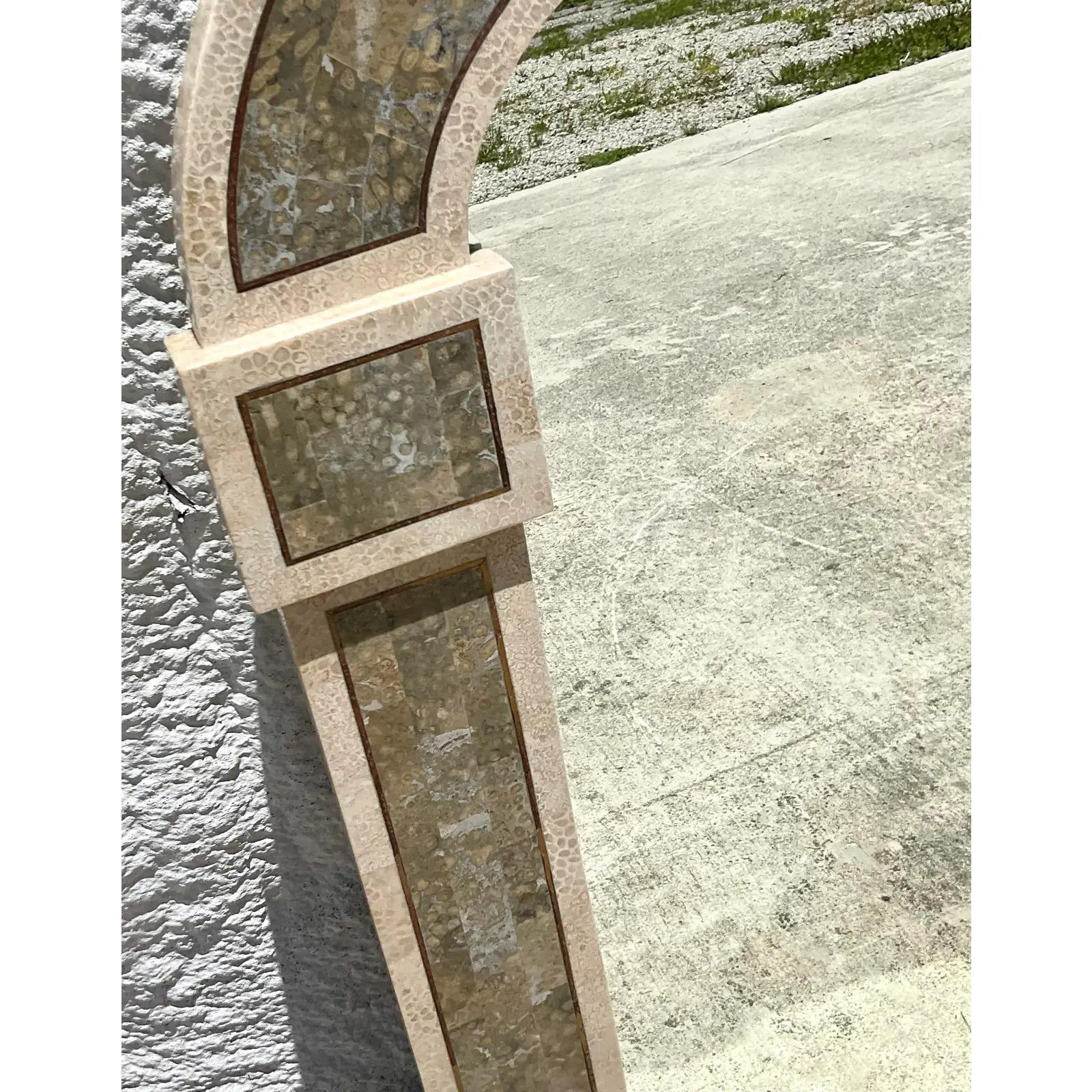 Vintage Regency Arched wall mirror. Beautiful tessellated stone in a chic two tone design. Brass inlay along the perimeter. Acquired from a Palm Beach estate.
