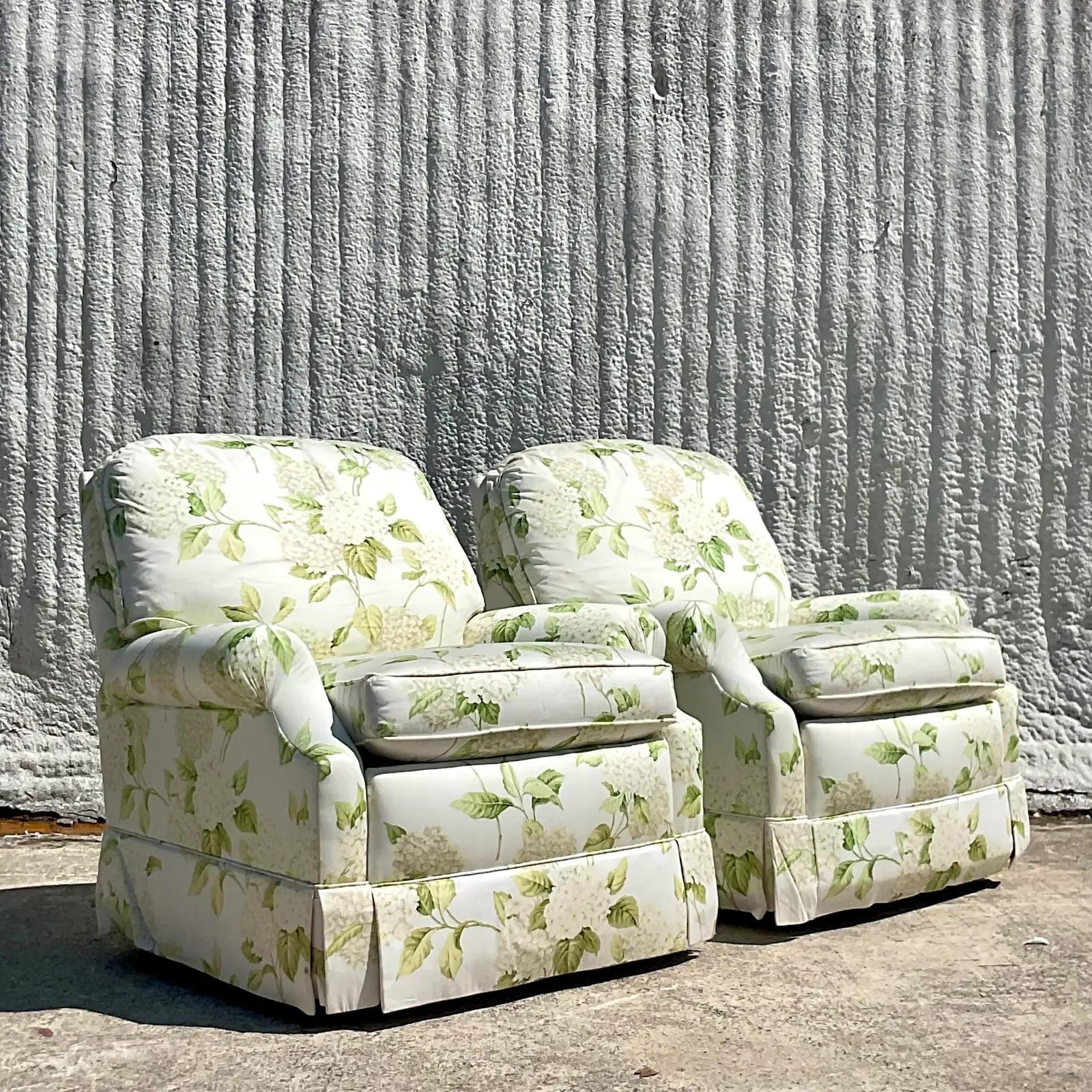 A fabulous pair of vintage Regency swivel rocker chairs. Made by the Sherrill group and upholstered in a Thibaut Hydrangea printed cotton sateen. Acquired from a Palm Beach estate.