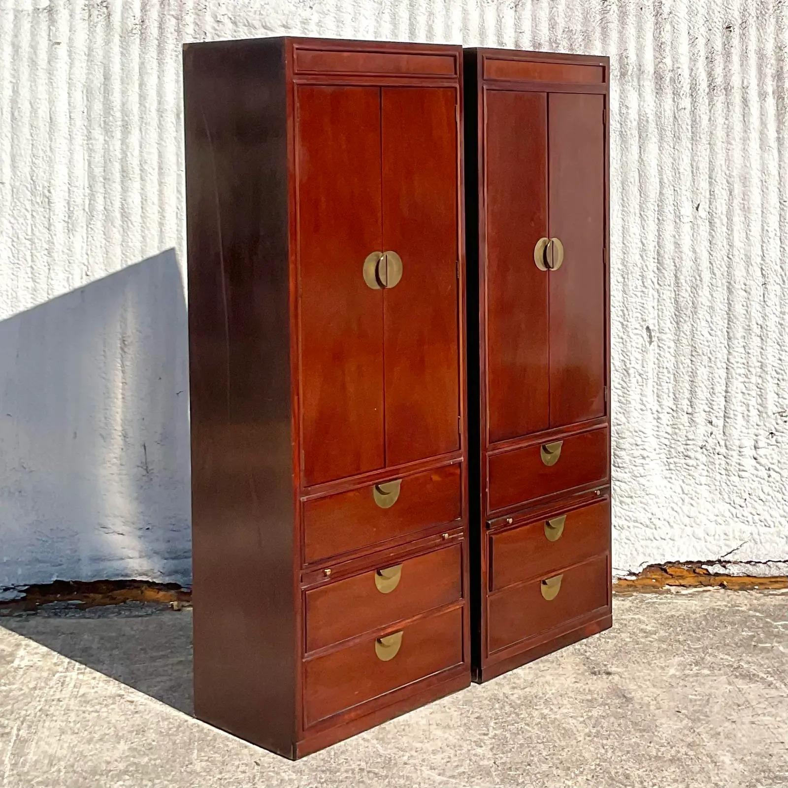 A fabulous pair of vintage Ming armoires. Made by the iconic Thomasville group. Rich wood with bright brass Ming medallion hardware. Pull out table top makes these cabinets super useful. Perfect as armoire or even chic nightstands. You decide!