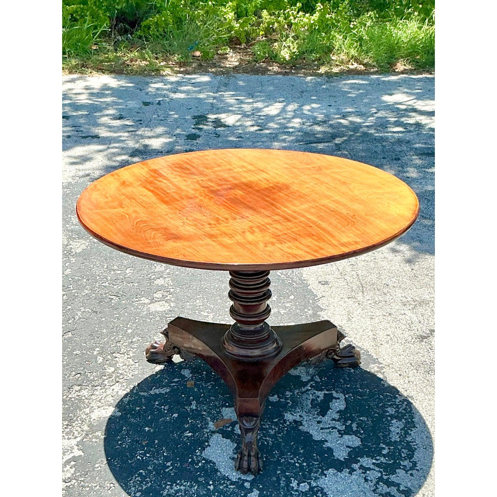 Discover the enduring elegance of the past with this magnificent Vintage Regency Tilt Top Table, a true gem for any discerning collector or interior designer. This exceptional piece embodies the refined aesthetics of the Regency period, featuring a