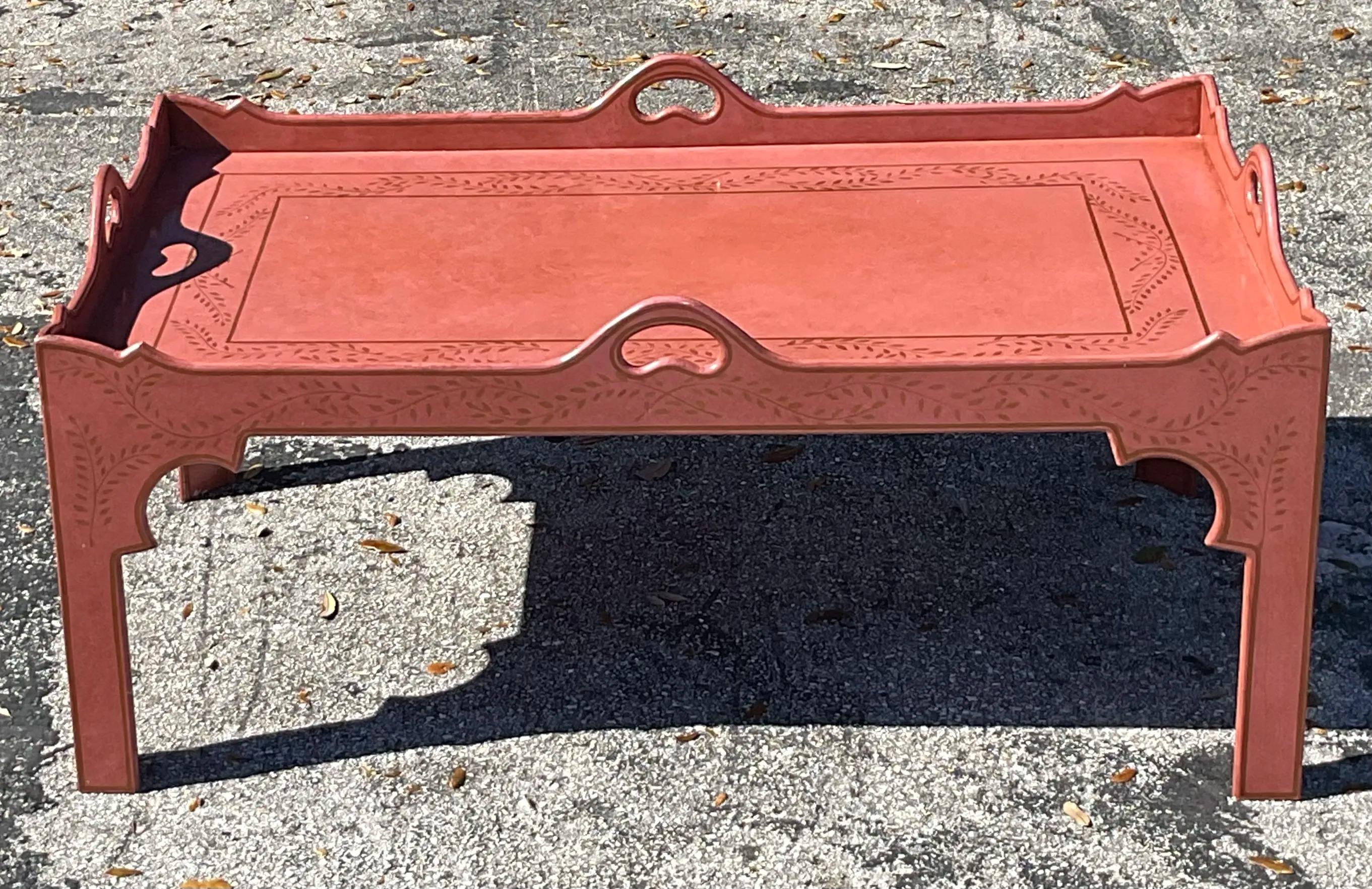 A stunning Vintage Regency coffee table featuring a tole-painted top with intricate designs, elegantly curved legs, and a sophisticated finish. This timeless piece adds a touch of classic charm and artistic flair to any living space.