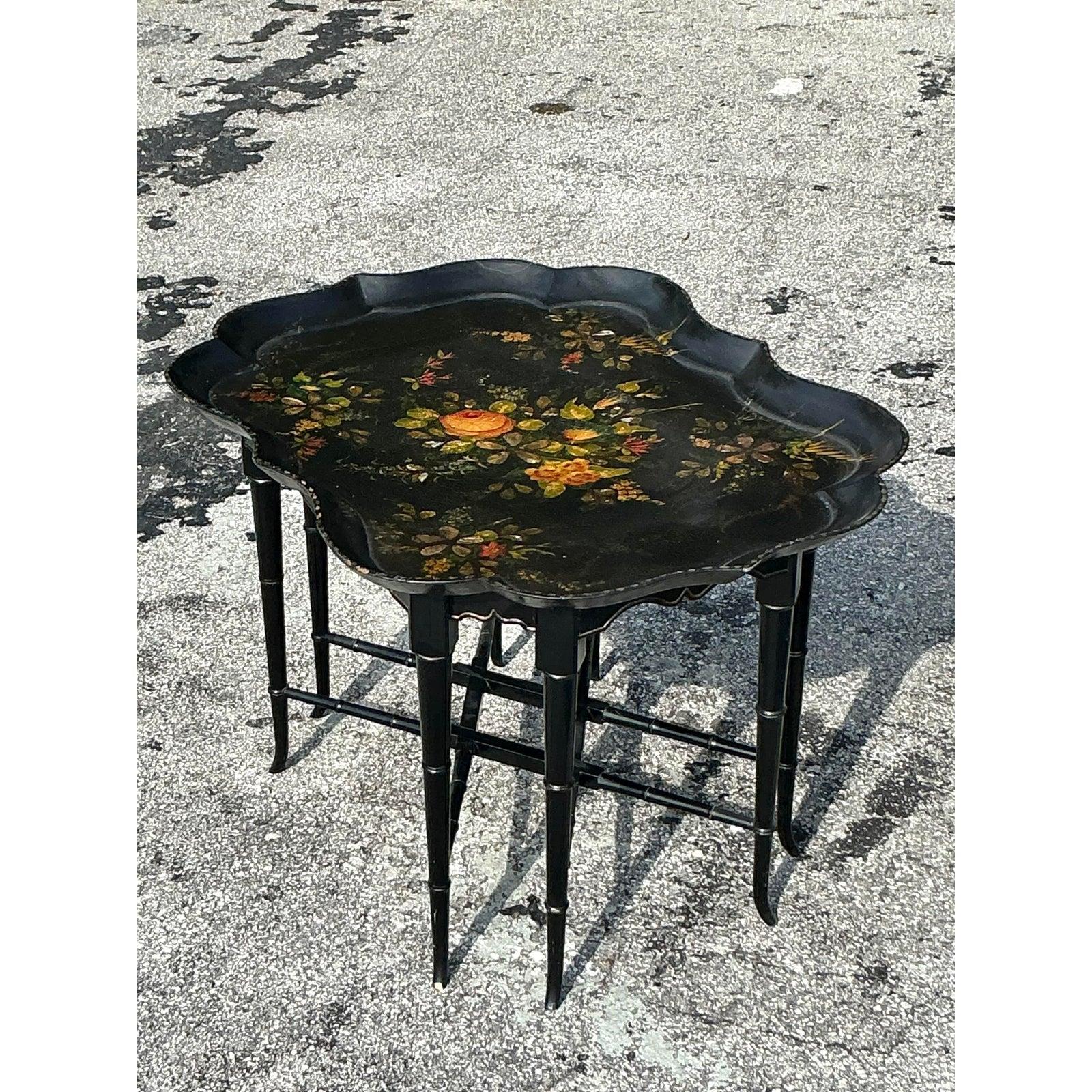 Add timeless elegance to your space with this exquisite Vintage Regency Tole Painted Tray Table. Featuring a beautifully scalloped silhouette and intricate floral tole painting, this piece captures the charm of classic English Regency style. The
