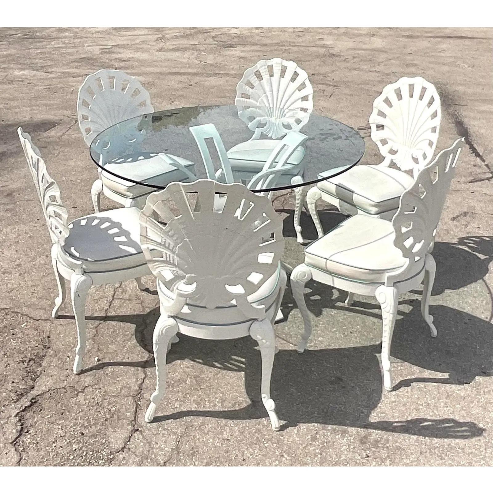 Fantastic set of 6 vintage Regency Cast aluminum outdoor dining chairs. Made by the iconic Tropitone group. Lacquered a high glow white with white seats and blue tipping. Unmarked.
