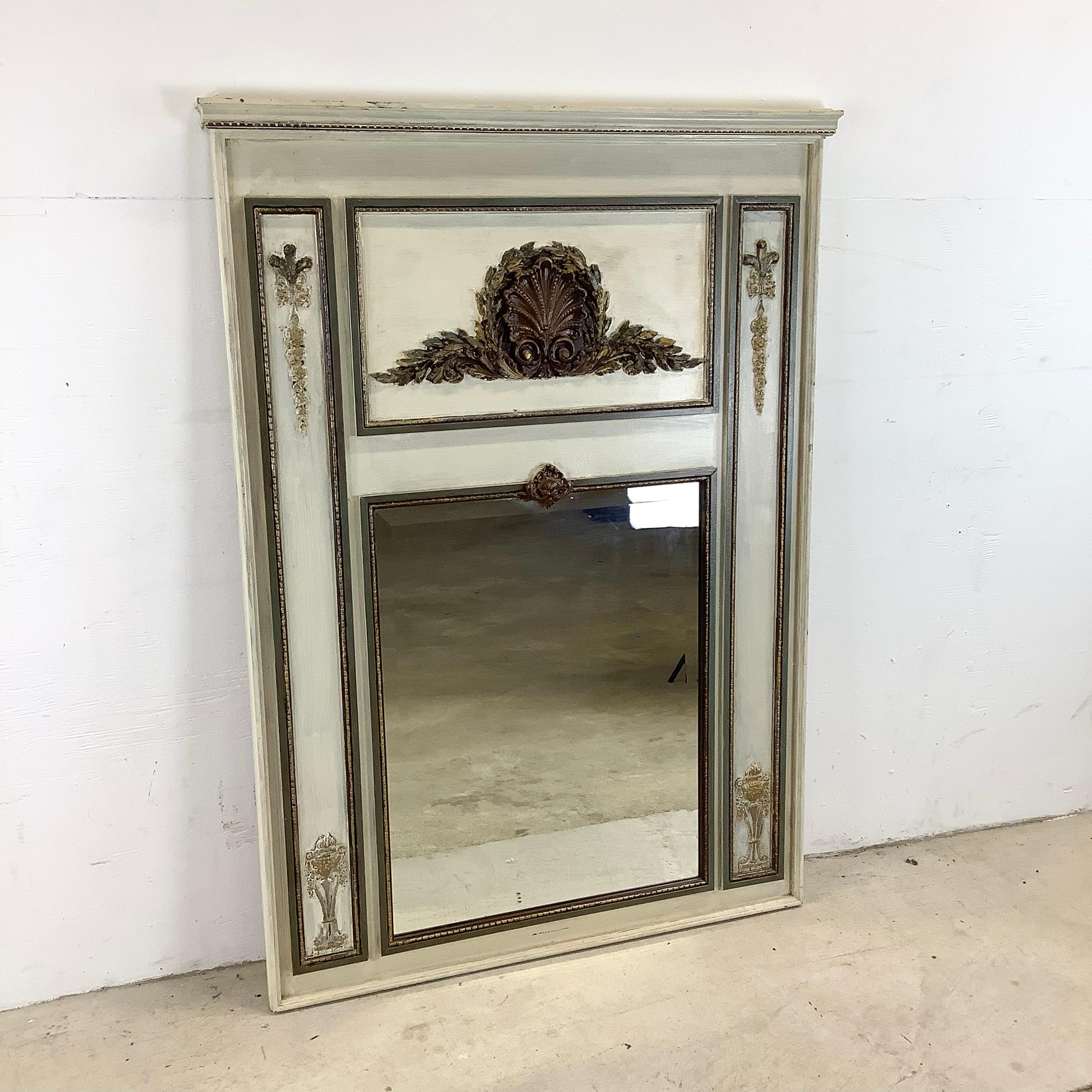 This striking vintage regency trumeau mirror makes a tremendous centerpiece to any setting, with ornate carved detail and painted finish. The french country style of the detailed wooden frame make this ready to hang trumeau mirror a perfect addition