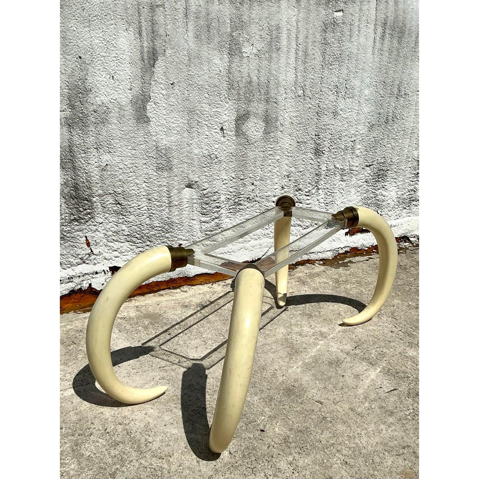 Make a bold statement with this iconic Vintage Regency Faux Elephant Tusk Dining Table, a design that perfectly captures the glamour of Hollywood Regency style. Attributed to the design of Springer and Eames, likely from the 1970s, this table