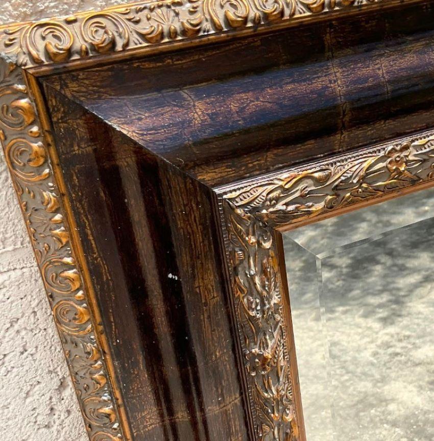 Gorgeous vintage wall mirror. A chic tortoise shell finish with gilt tipping. Large and impressive. Acquired from a Palm Beach estate.
