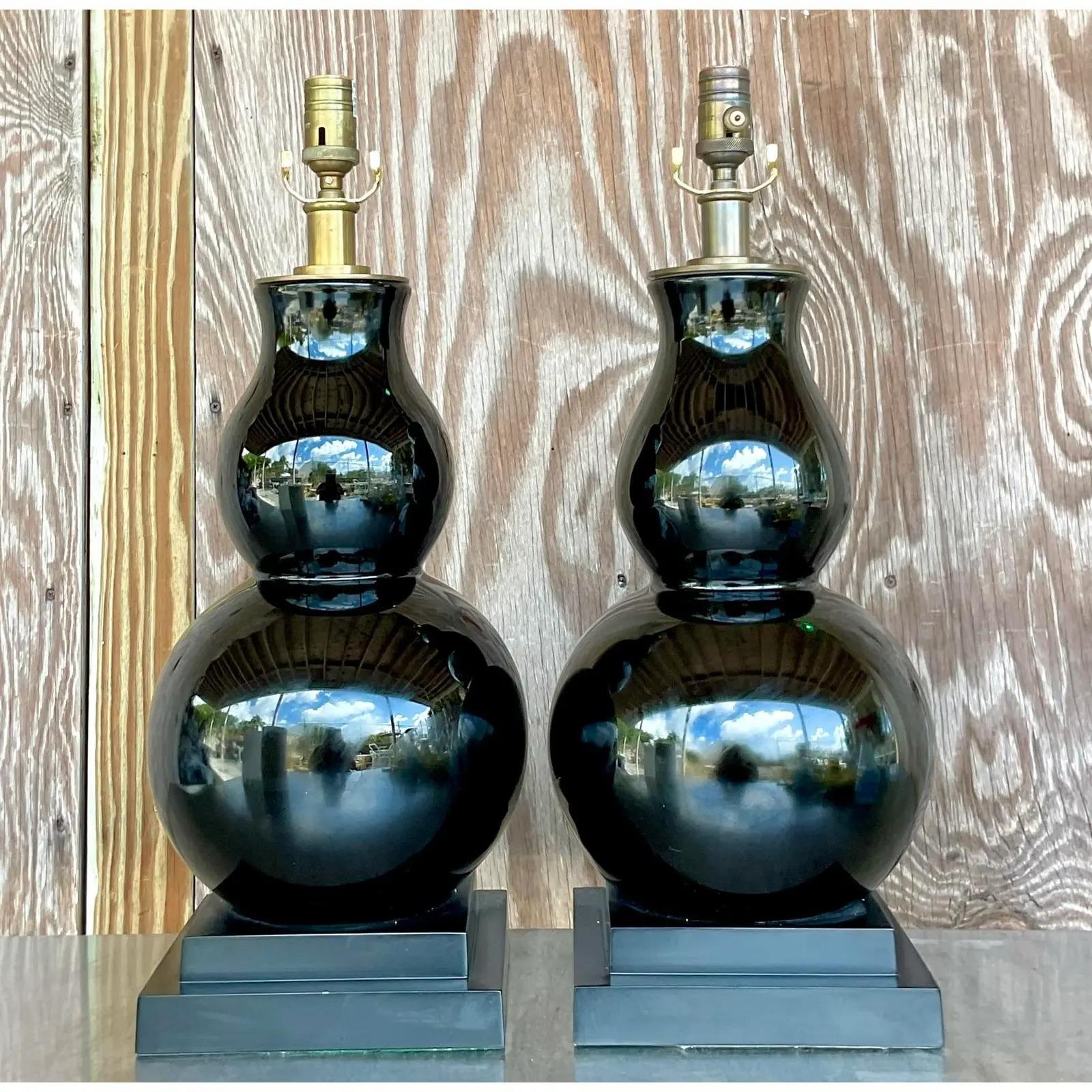 A fantastic pair of vintage Regency table lamps. Designed by Chapman and Myers for Visual Comfort. The “Fang” style with a classic gourd shape and brass hardware. Acquired from a Palm Beach estate.